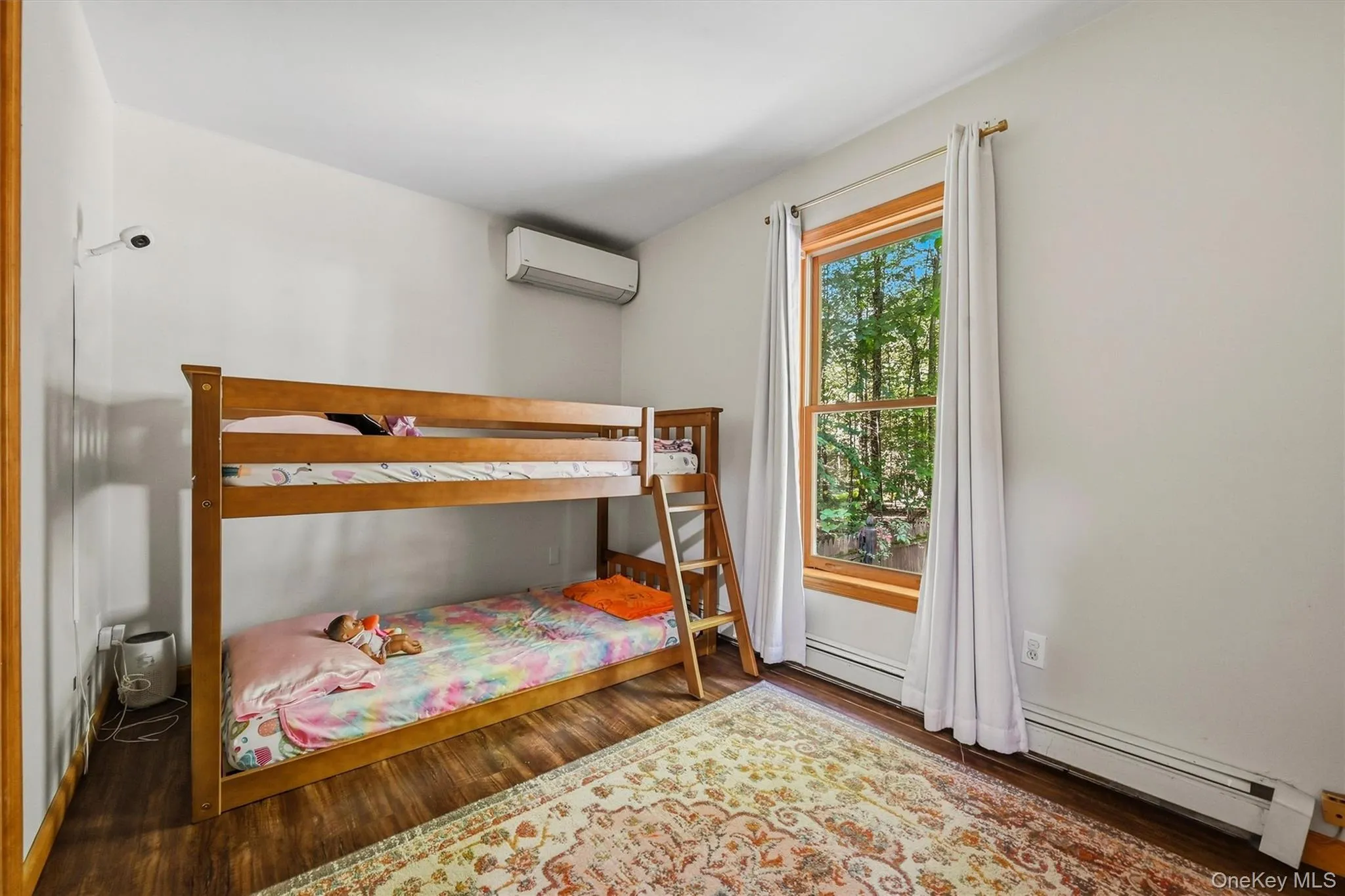 Wood-finish flooring, white painted walls, and a wood-trimmed window Wood-finish flooring, white painted walls, and a wood-trimmed window