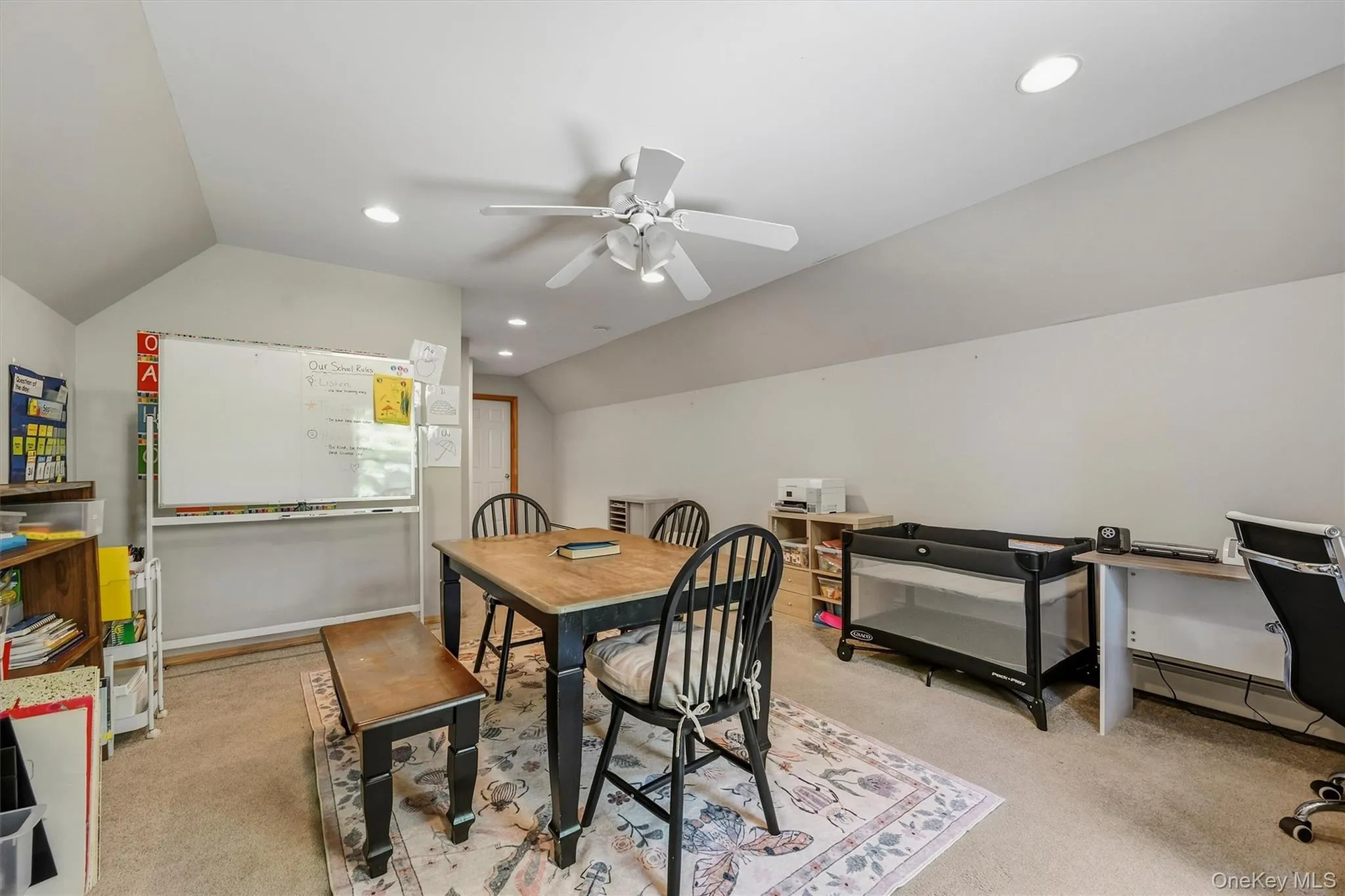 Vaulted ceiling with recessed lighting, ceiling fan, and neutral carpeting Vaulted ceiling with recessed lighting, ceiling fan, and neutral carpeting