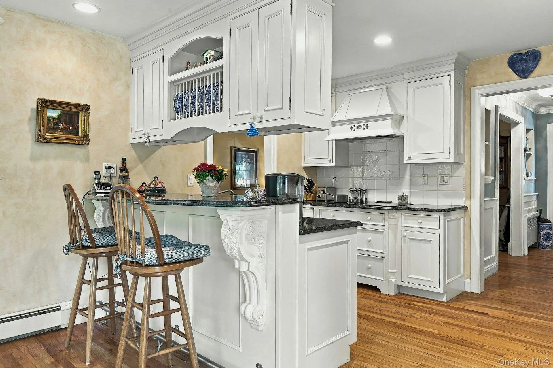 Updated kitchen with granite island and hardwood flooring. Updated kitchen with granite island and hardwood flooring.