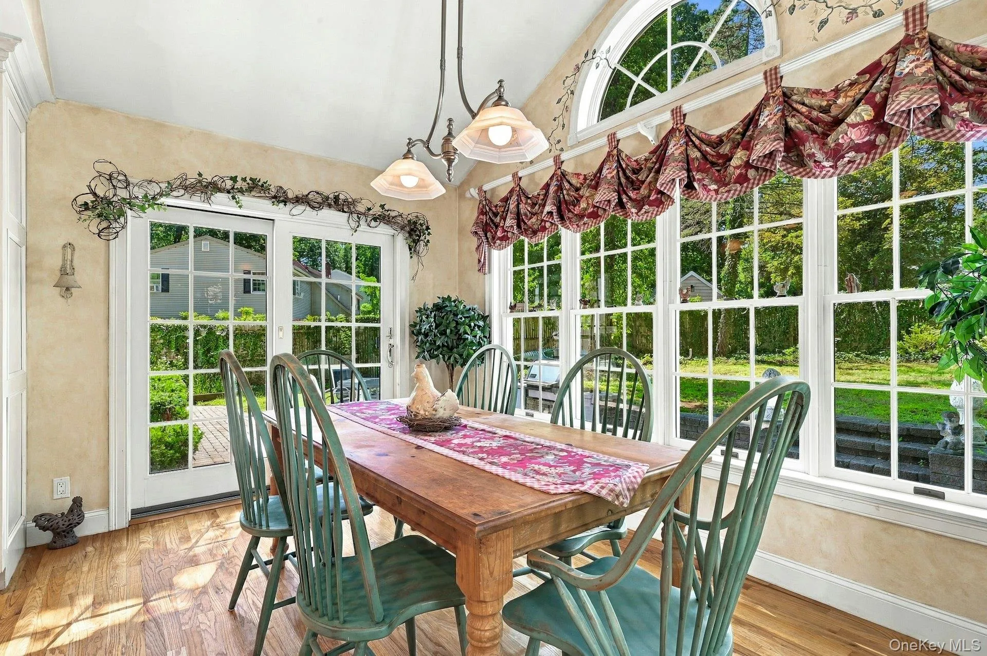 Dining area with french doors overlooking backyard and patio Dining area with french doors overlooking backyard and patio