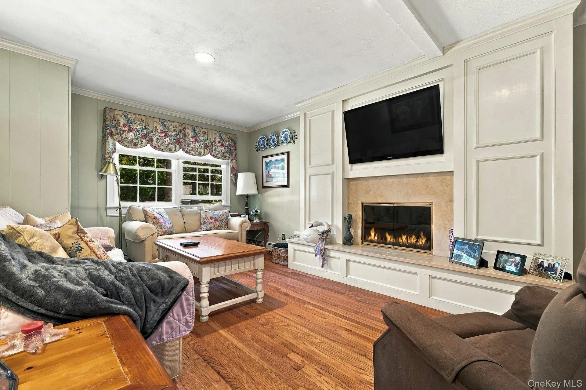 Fireplace, hardwood flooring off of kitchen with half bath in hall . Fireplace, hardwood flooring off of kitchen with half bath in hall .