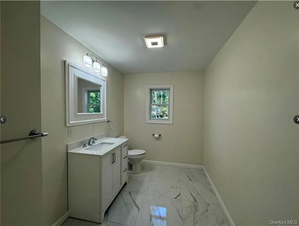 Bathroom featuring vanity and toilet Bathroom featuring vanity and toilet