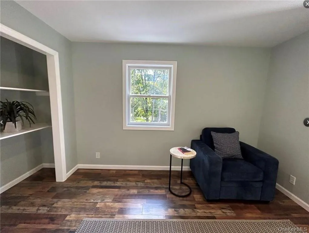 Sitting room with dark wood-type flooring Sitting room with dark wood-type flooring
