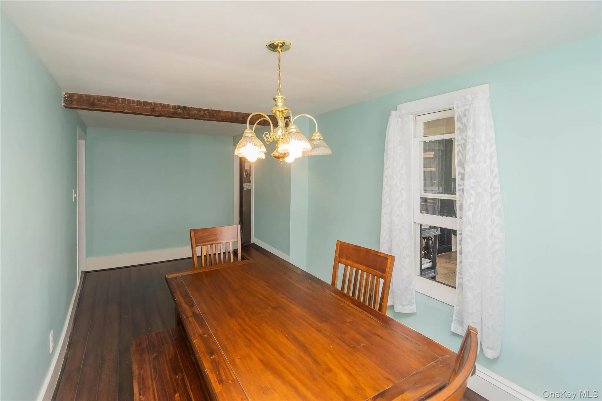 Unfurnished dining area with a chandelier and dark wood finished floors Unfurnished dining area with a chandelier and dark wood finished floors