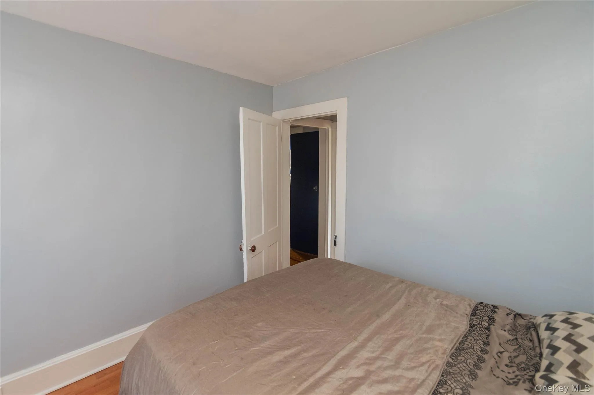 Bedroom with baseboards and wood finished floors Bedroom with baseboards and wood finished floors