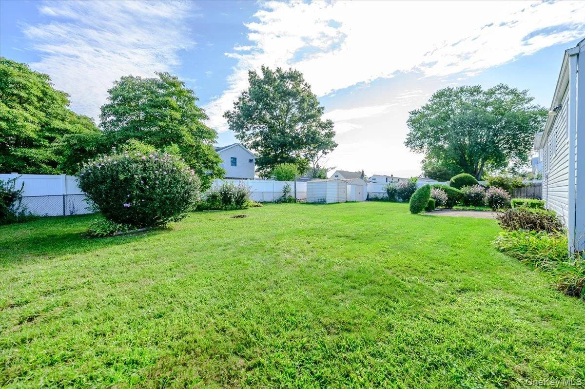 Expansive backyard with mature landscaping, including established trees and lush lawn space Expansive backyard with mature landscaping, including established trees and lush lawn space