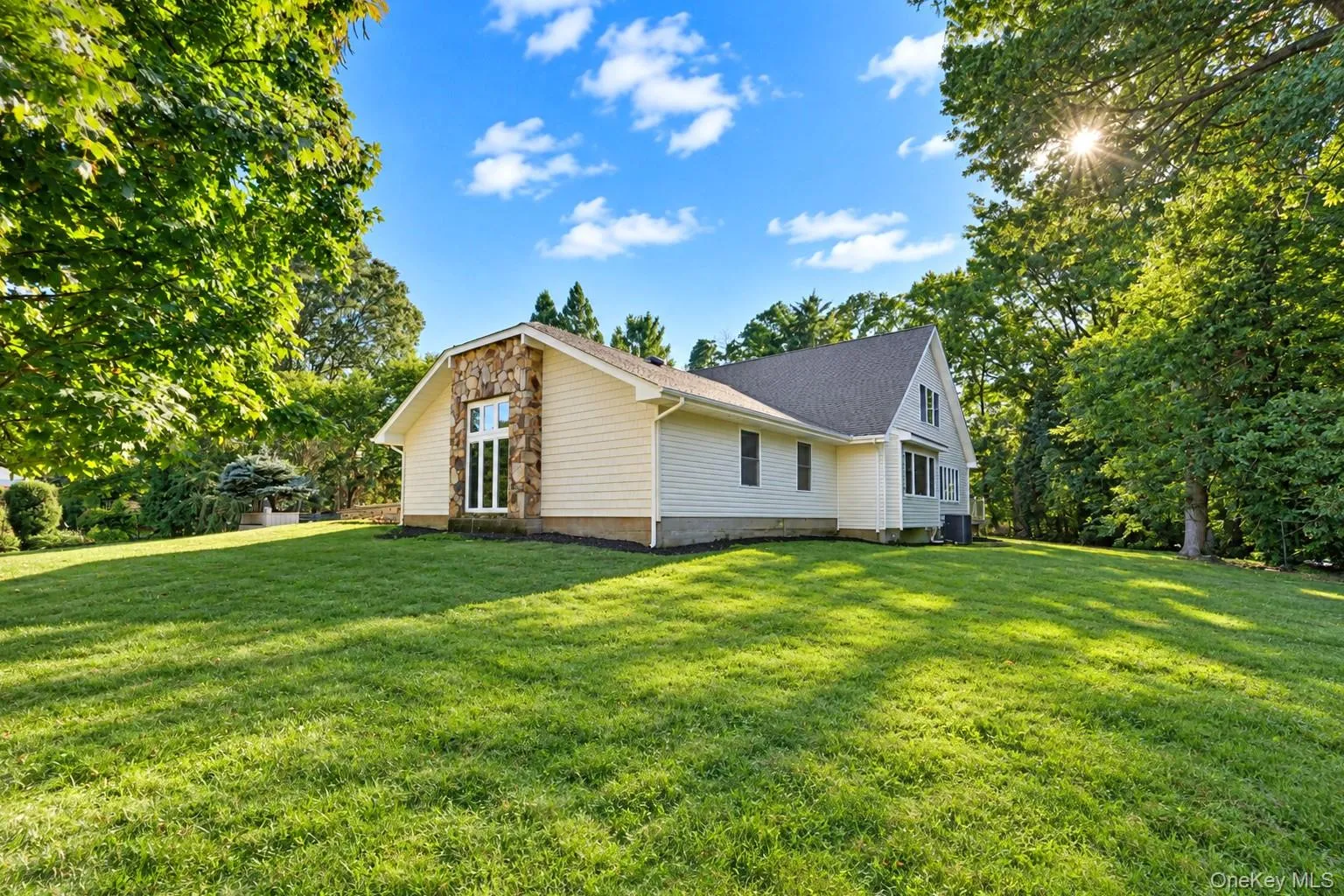 Expansive green lawn surrounding the property Expansive green lawn surrounding the property