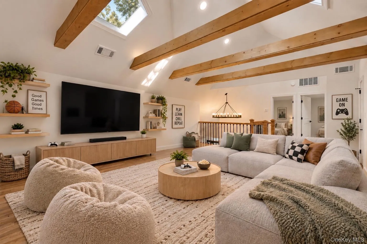 High vaulted ceiling with exposed wood beams, wood-finish flooring, staircase with wrought iron balusters and wood newel posts, and recessed lighting High vaulted ceiling with exposed wood beams, wood-finish flooring, staircase with wrought iron balusters and wood newel posts, and recessed lighting