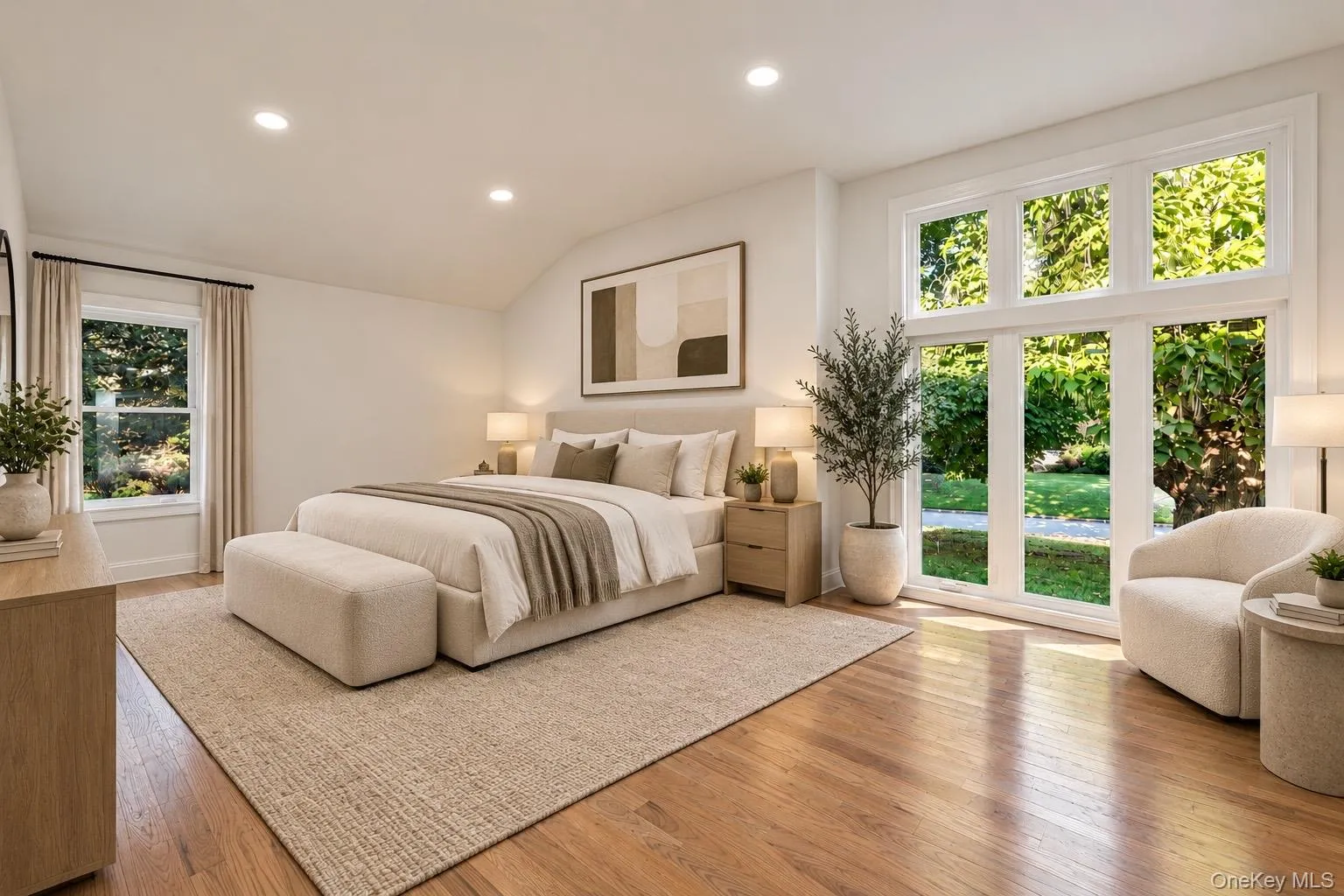 Wood-finish flooring, recessed lighting, and a large multi-pane window with additional transom windows Wood-finish flooring, recessed lighting, and a large multi-pane window with additional transom windows