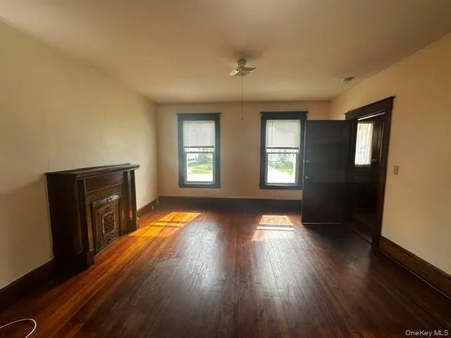 Hardwood flooring, decorative fireplace, two large windows, white ceiling, Hardwood flooring, decorative fireplace, two large windows, white ceiling,