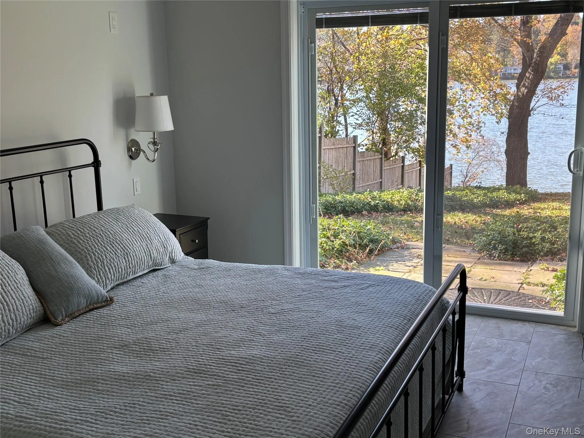 Bedroom with a water view and access to outside Bedroom with a water view and access to outside