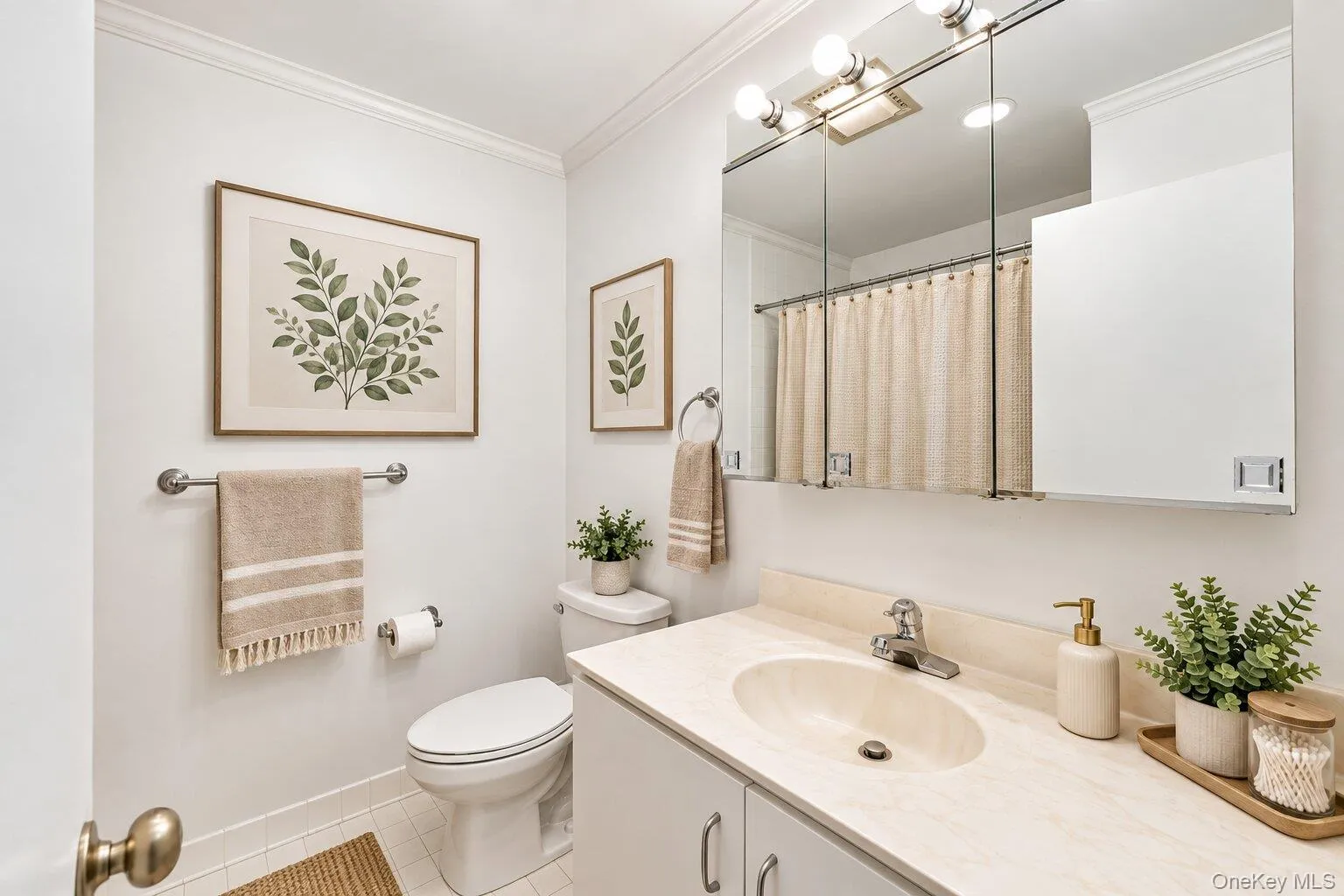 White vanity with an integrated oval sink, chrome faucet, and mirrored medicine cabinet White vanity with an integrated oval sink, chrome faucet, and mirrored medicine cabinet
