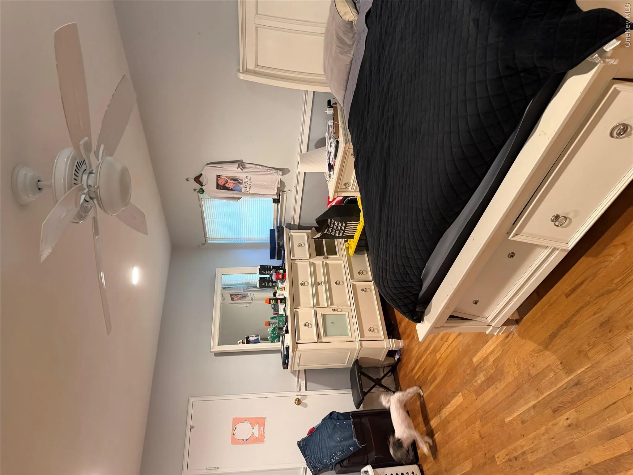 Over sized primary suite with his and hers closets. Hardwood flooring, recessed lighting, ceiling fan with light fixture, window with blinds Over sized primary suite with his and hers closets. Hardwood flooring, recessed lighting, ceiling fan with light fixture, window with blinds