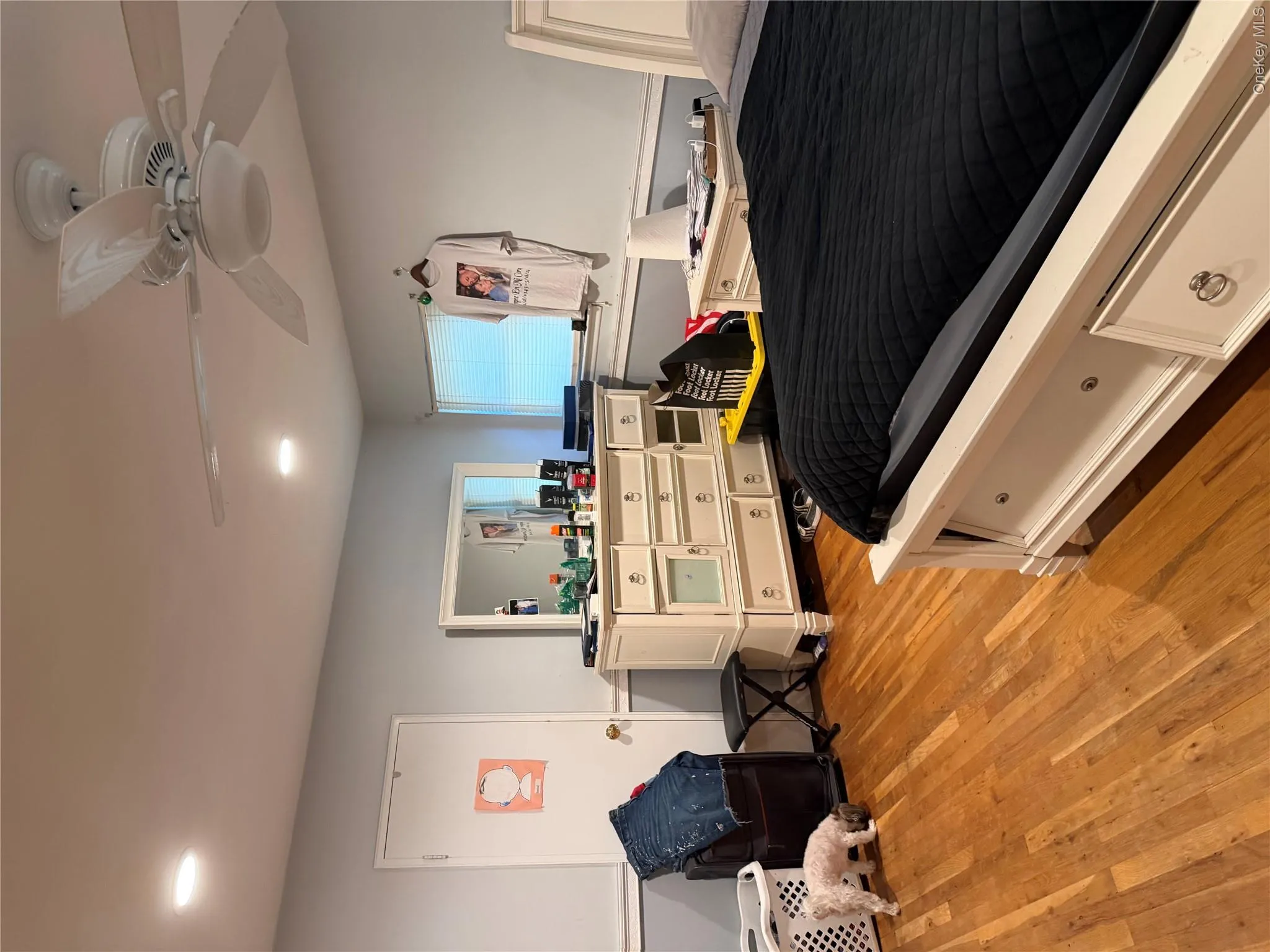 Over sized primary suite with his and hers closets. Hardwood flooring, recessed lighting, ceiling fan with light fixture, window with blinds Over sized primary suite with his and hers closets. Hardwood flooring, recessed lighting, ceiling fan with light fixture, window with blinds