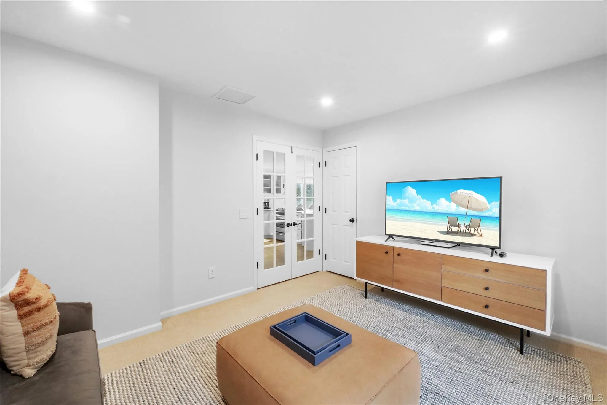 Living room with french doors, recessed lighting, and light carpet Living room with french doors, recessed lighting, and light carpet