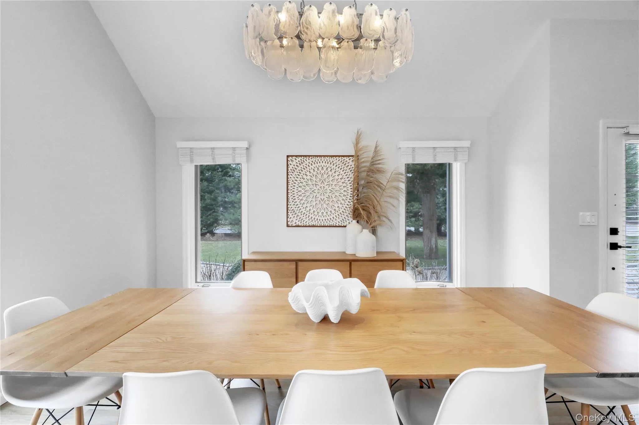 Dining space featuring healthy amount of natural light and lofted ceiling Dining space featuring healthy amount of natural light and lofted ceiling