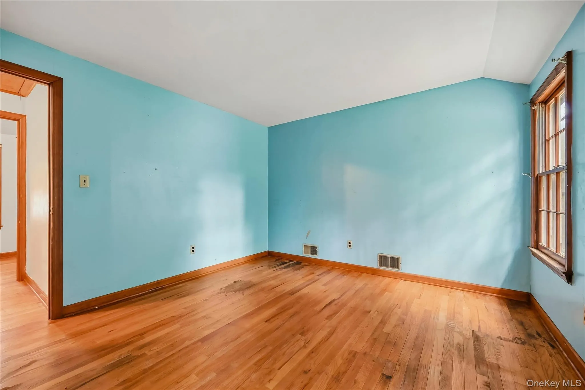 Hardwood flooring, window with wood trim, wood door frame Hardwood flooring, window with wood trim, wood door frame