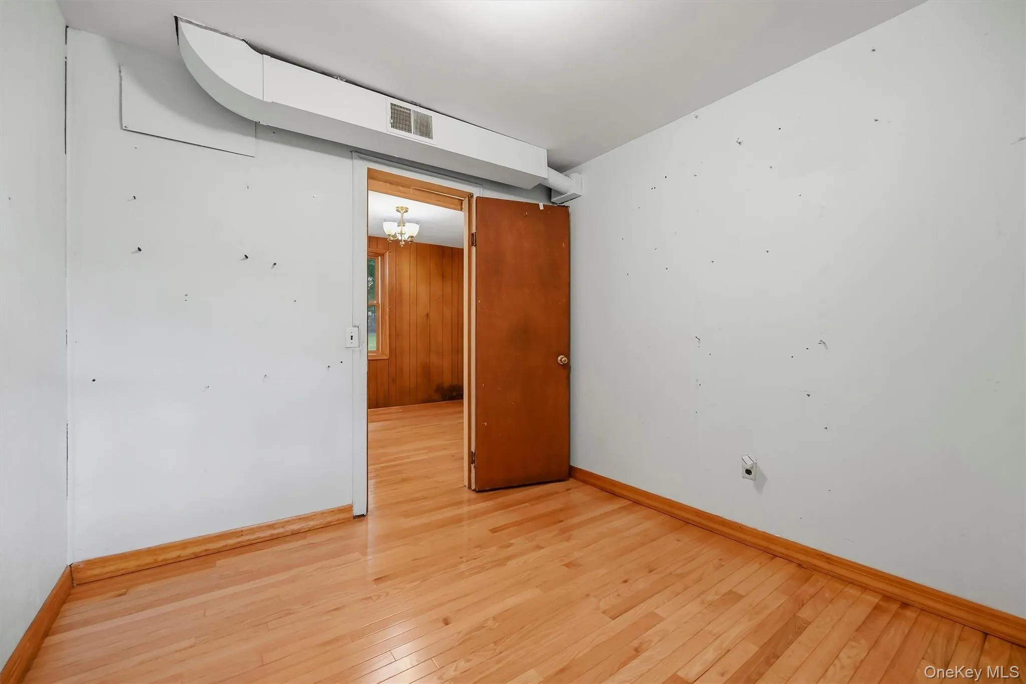 Hardwood flooring throughout, white painted walls, and wood trim Hardwood flooring throughout, white painted walls, and wood trim