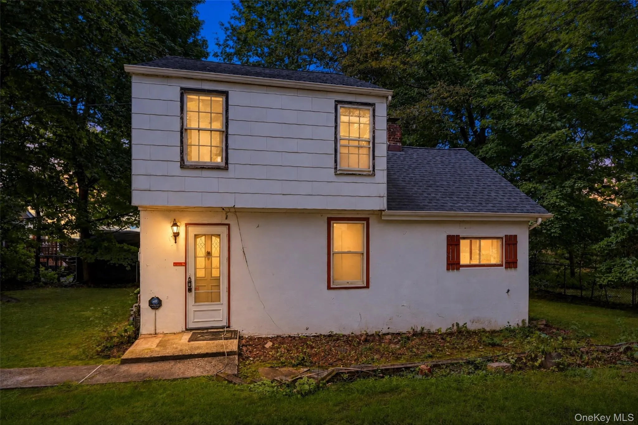 White siding exterior with a dark-shingled roof White siding exterior with a dark-shingled roof