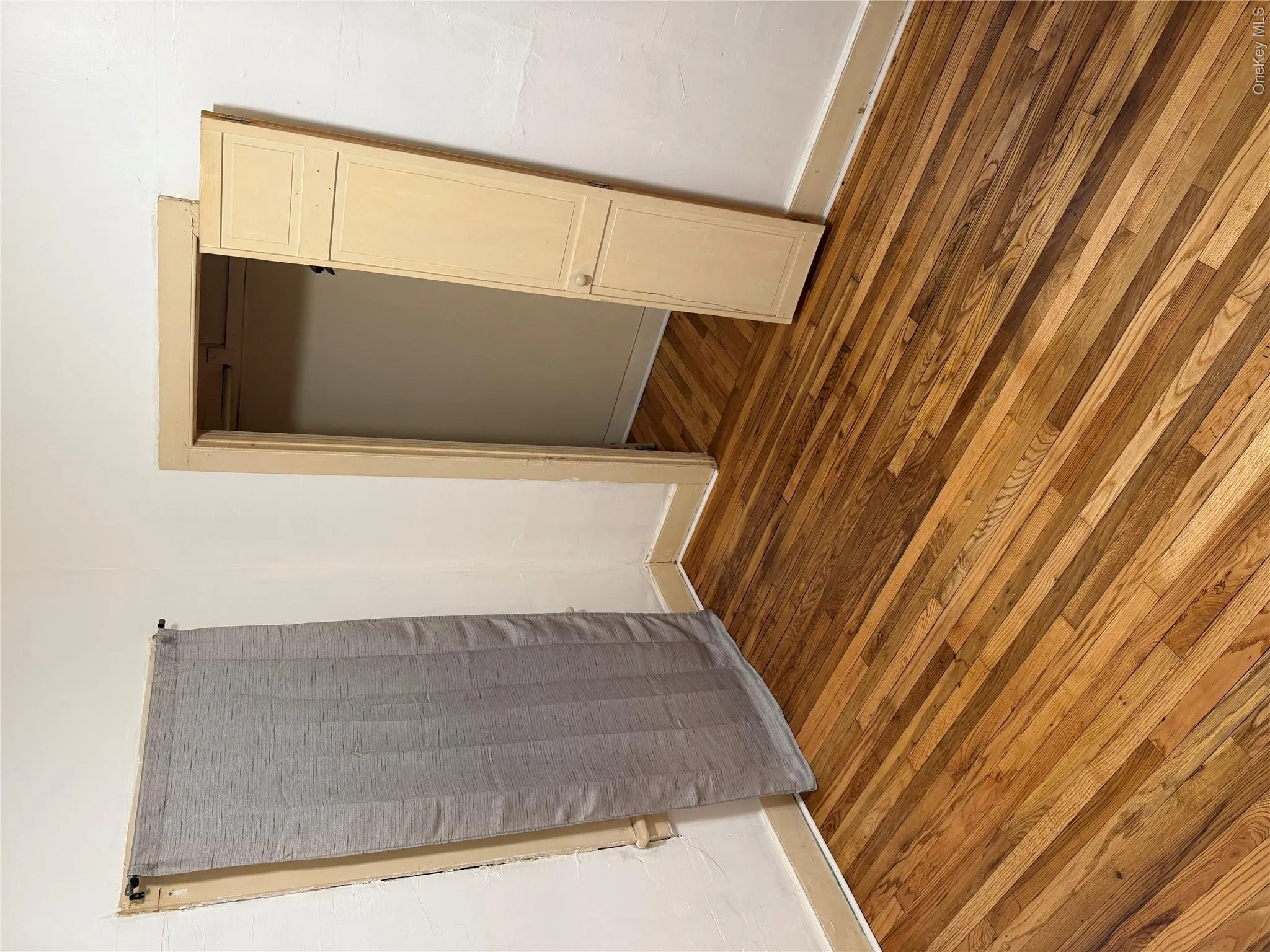 Unfurnished bedroom featuring dark wood finished floors and baseboards Unfurnished bedroom featuring dark wood finished floors and baseboards