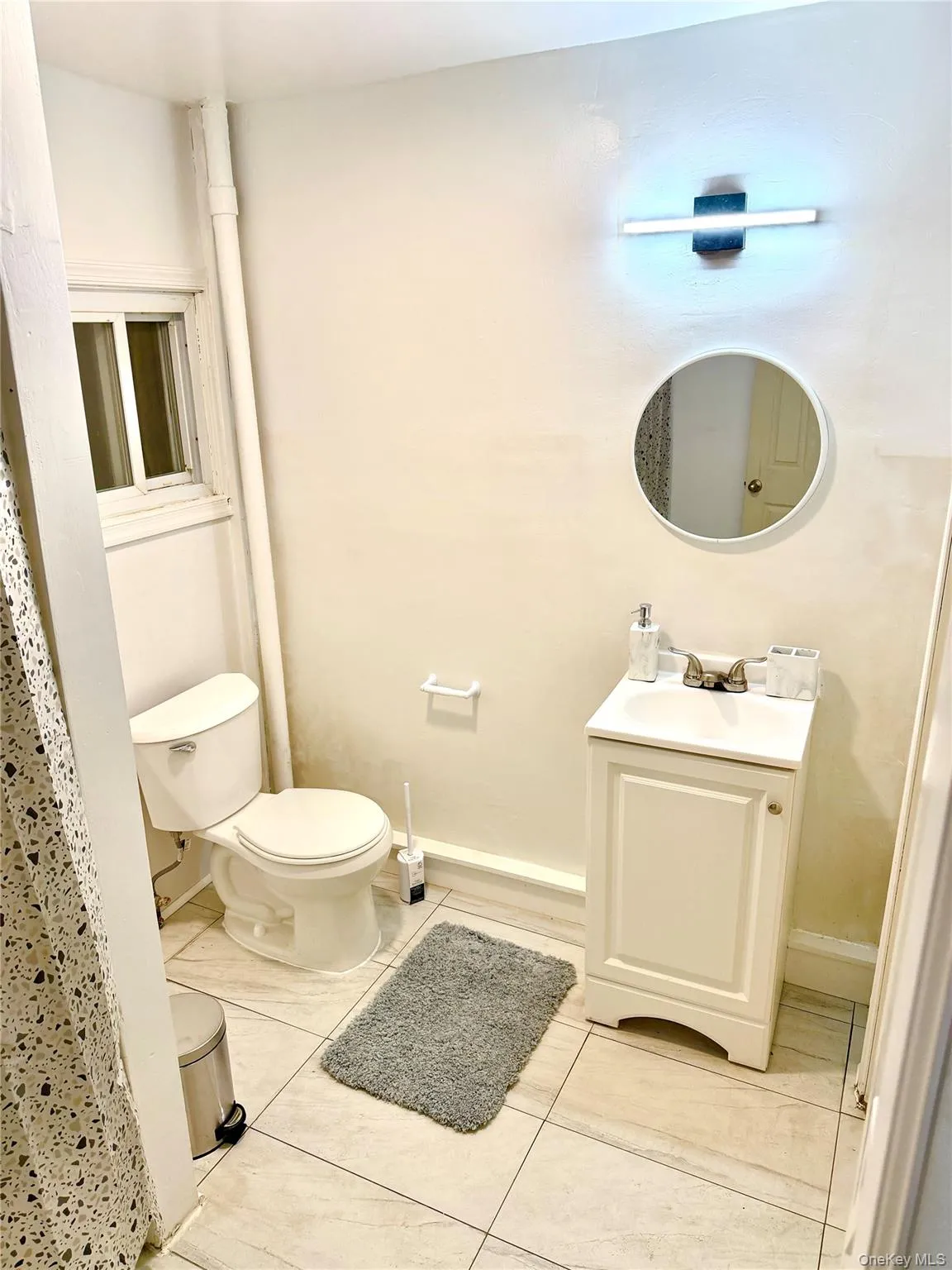 Bathroom with vanity and light tile patterned flooring Bathroom with vanity and light tile patterned flooring