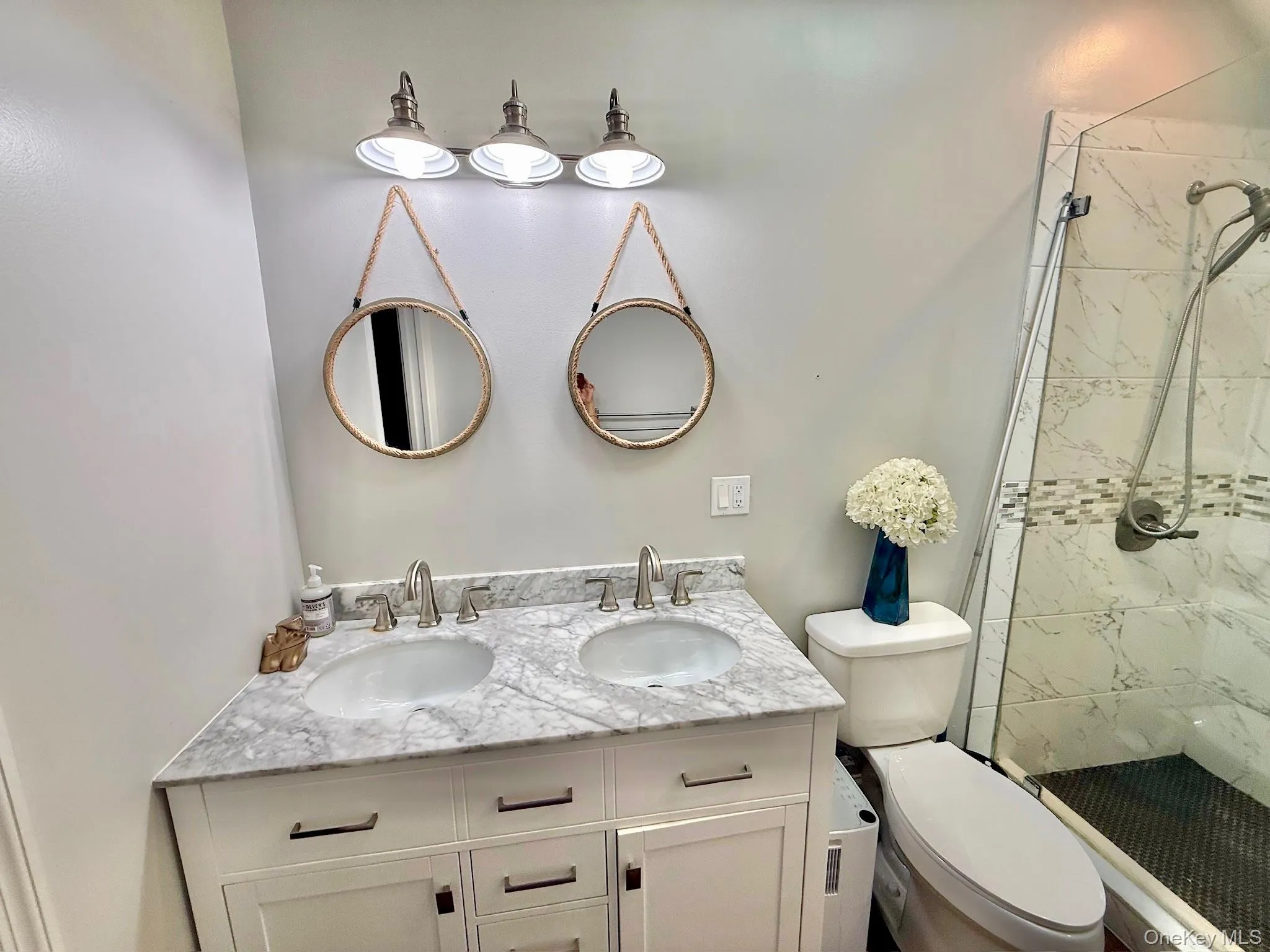 Cottage In The Back Bathroom Dual vanity with stone countertop, undermount sinks, and brushed nickel fixtures Cottage In The Back Bathroom Dual vanity with stone countertop, undermount sinks, and brushed nickel fixtures