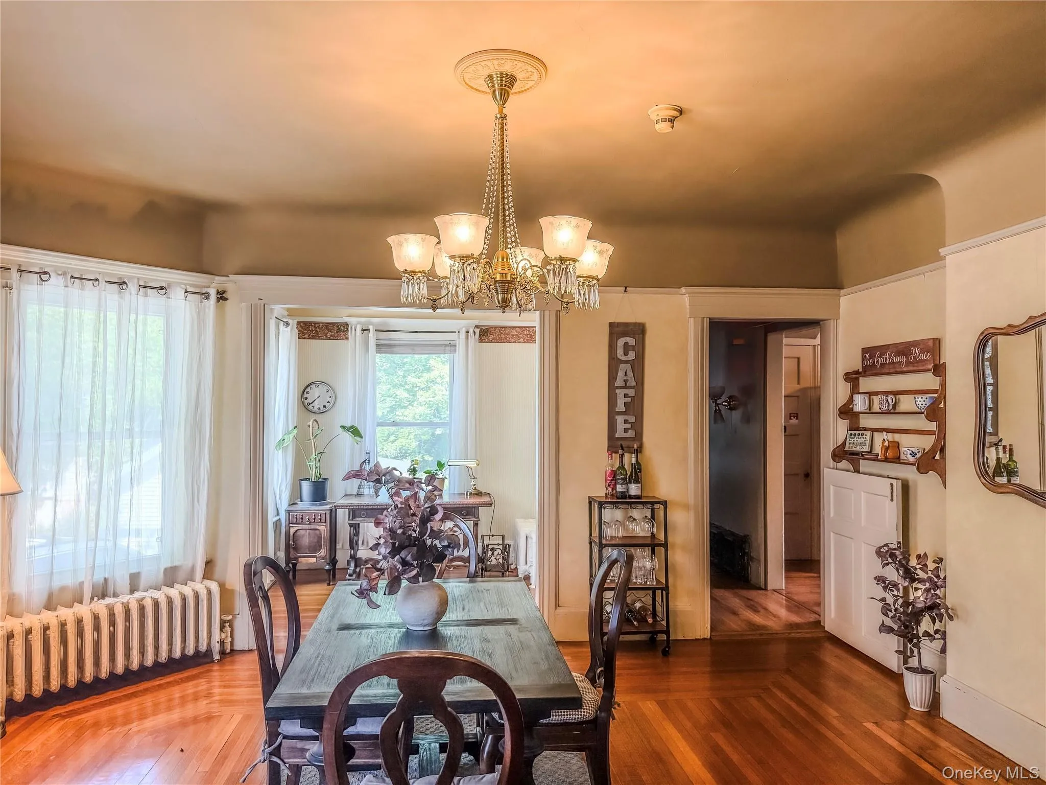 Main House Dining Hardwood flooring, bay window and chandelier lighting Main House Dining Hardwood flooring, bay window and chandelier lighting