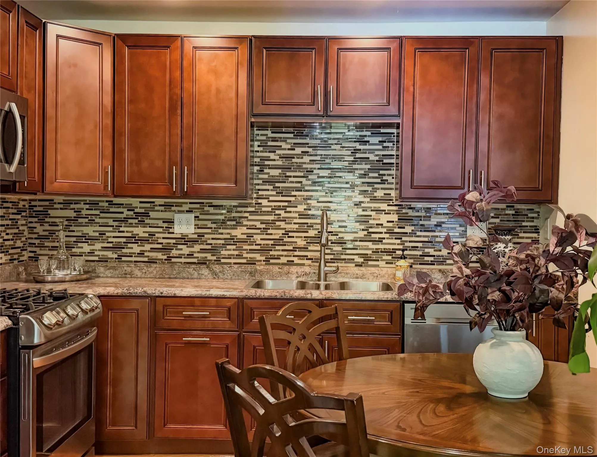 Lower Apartment Kitchen featuring wood-finish cabinetry, stainless steel appliances, eat-in kitchen area Lower Apartment Kitchen featuring wood-finish cabinetry, stainless steel appliances, eat-in kitchen area