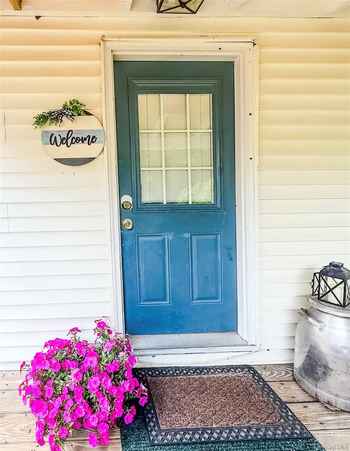 Lower apartment of two story structure in back of main house. with blue door and glass paneling Lower apartment of two story structure in back of main house. with blue door and glass paneling