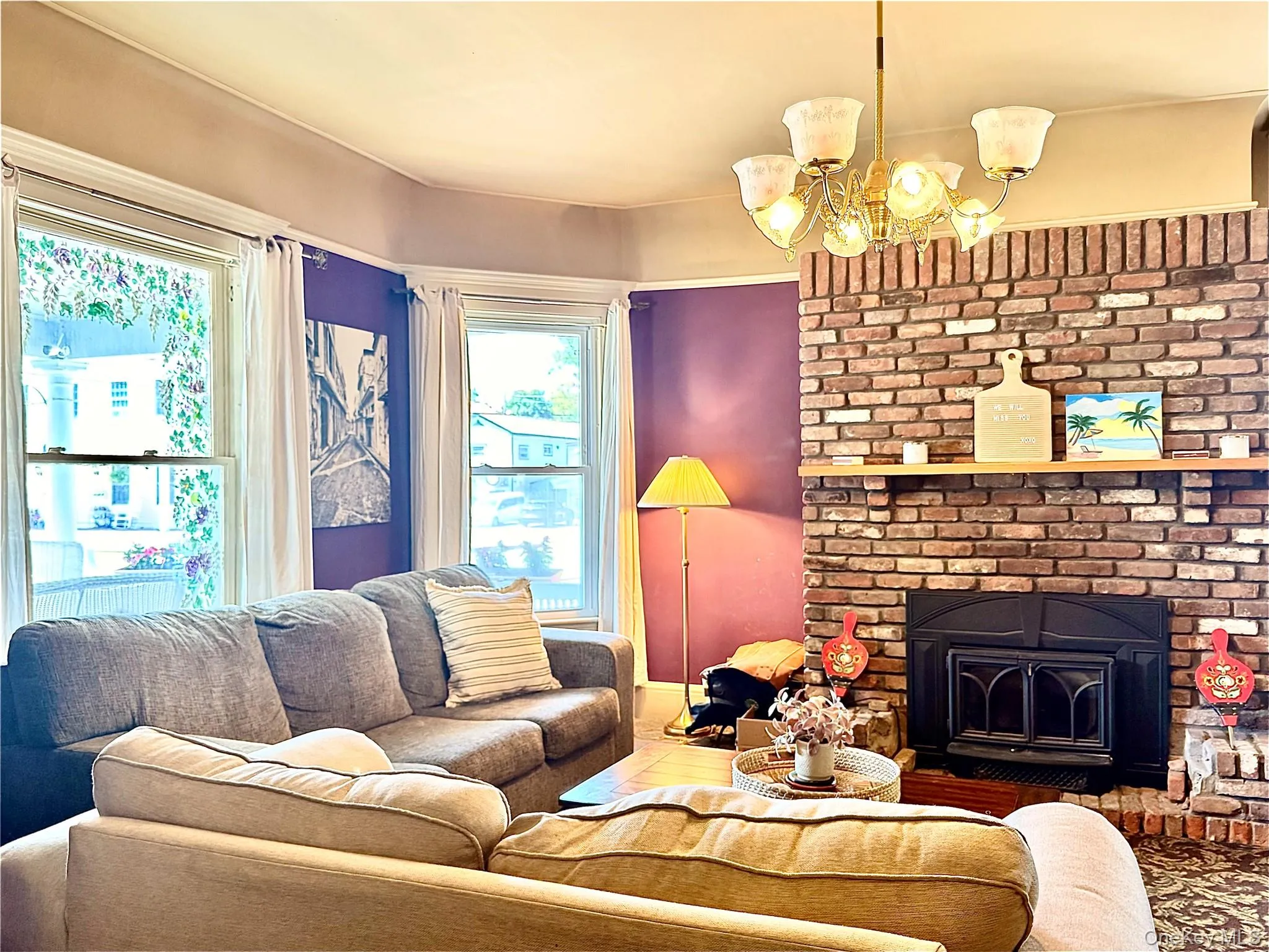 Main House Living Room Brick fireplace with large windows Main House Living Room Brick fireplace with large windows