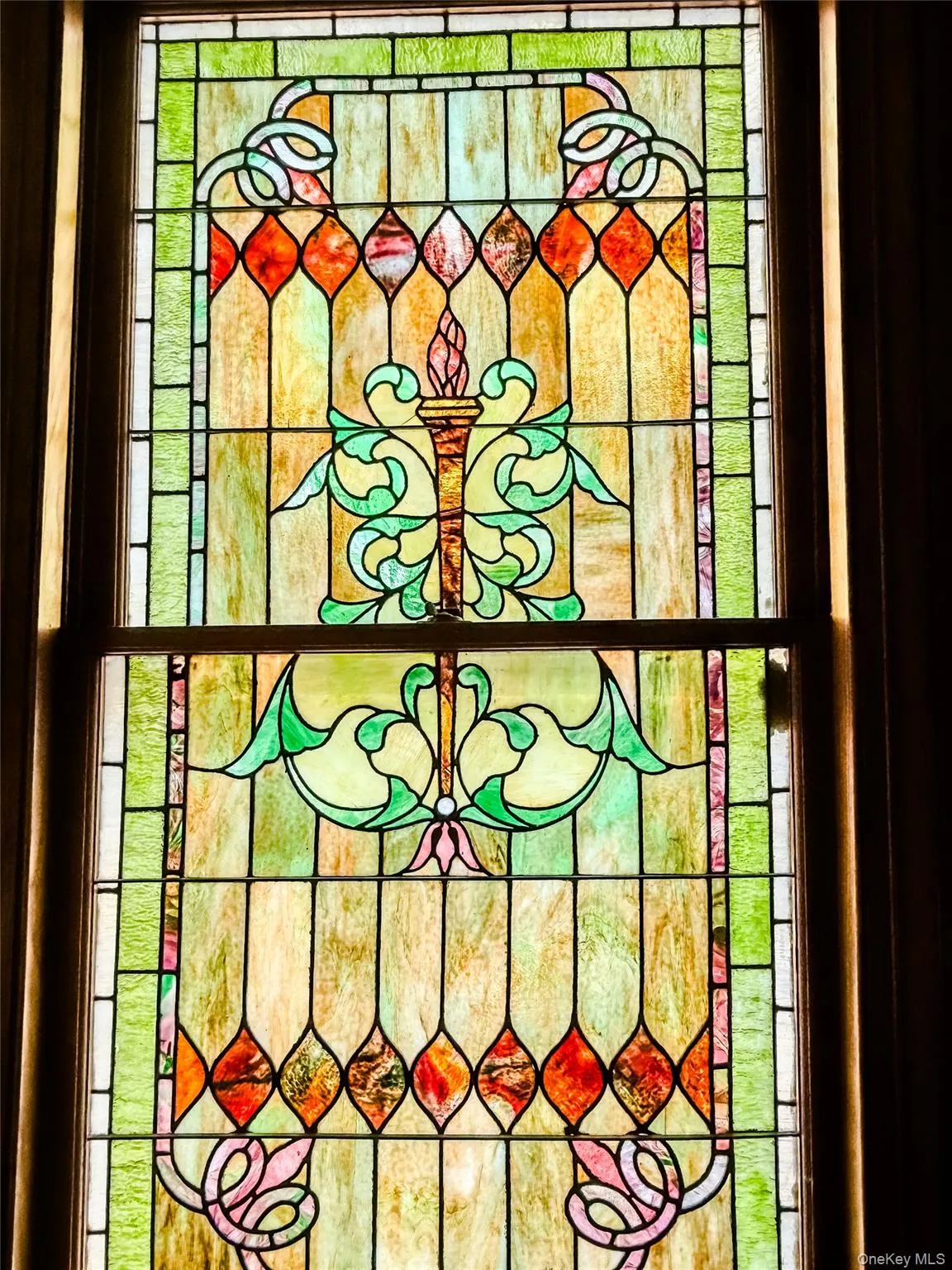 Stained glass window featuring an ornate, multi-color design Stained glass window featuring an ornate, multi-color design
