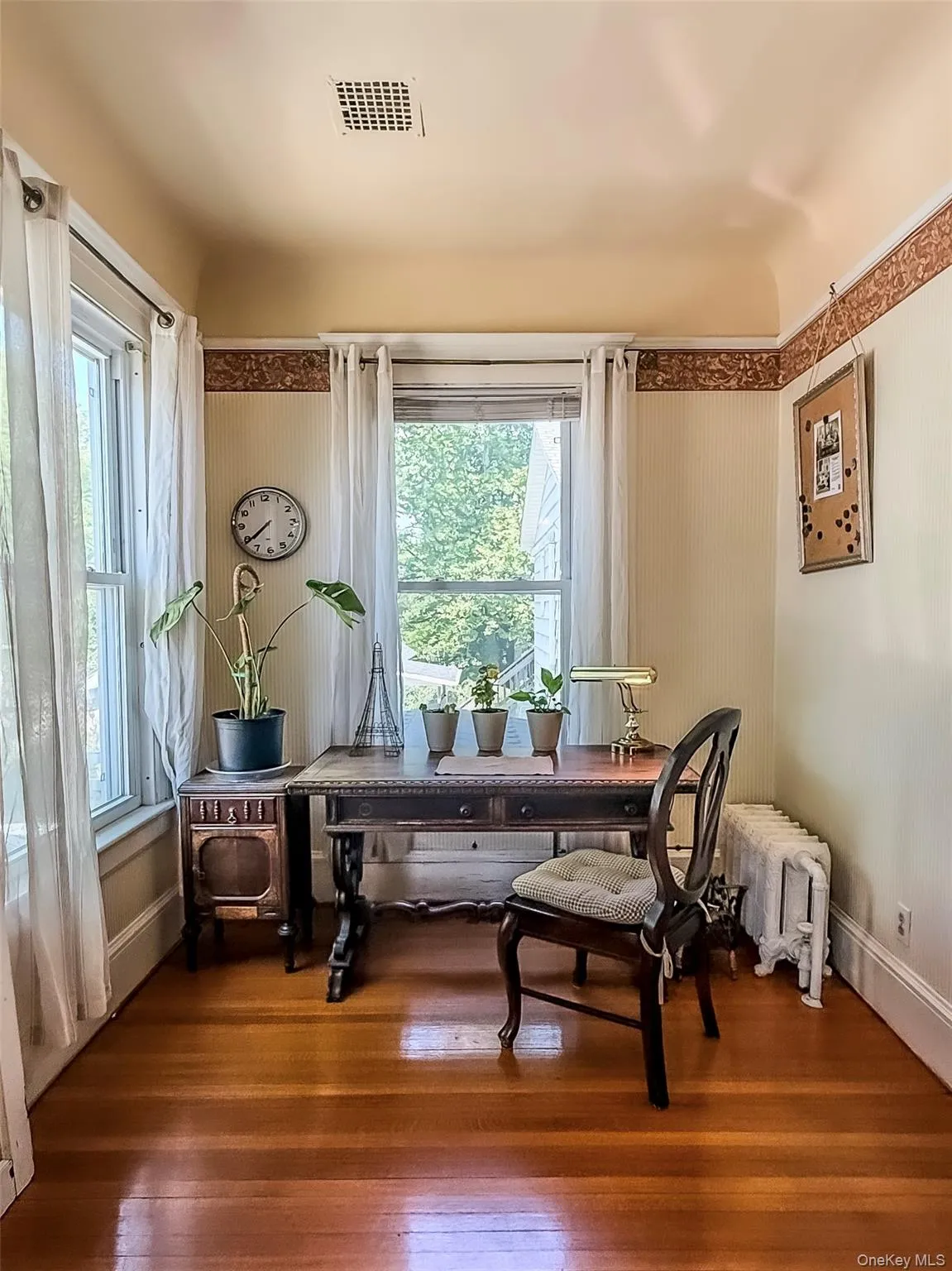 Office Nook off Dining Room with hardwood flooring, painted walls with decorative border and white trim Office Nook off Dining Room with hardwood flooring, painted walls with decorative border and white trim