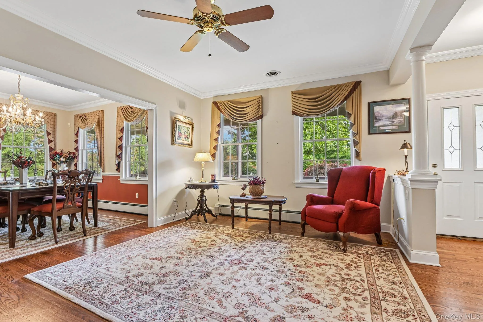 Wood-finish flooring, crown molding, and a ceiling fan with integrated lighting Wood-finish flooring, crown molding, and a ceiling fan with integrated lighting