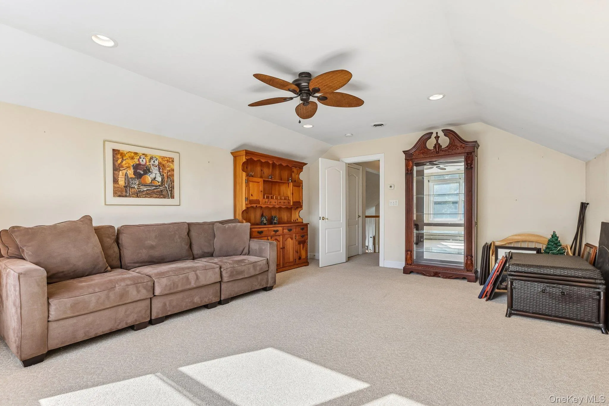 Recessed lighting, sloped ceiling, ceiling fan, neutral wall paint, and carpeted flooring Recessed lighting, sloped ceiling, ceiling fan, neutral wall paint, and carpeted flooring