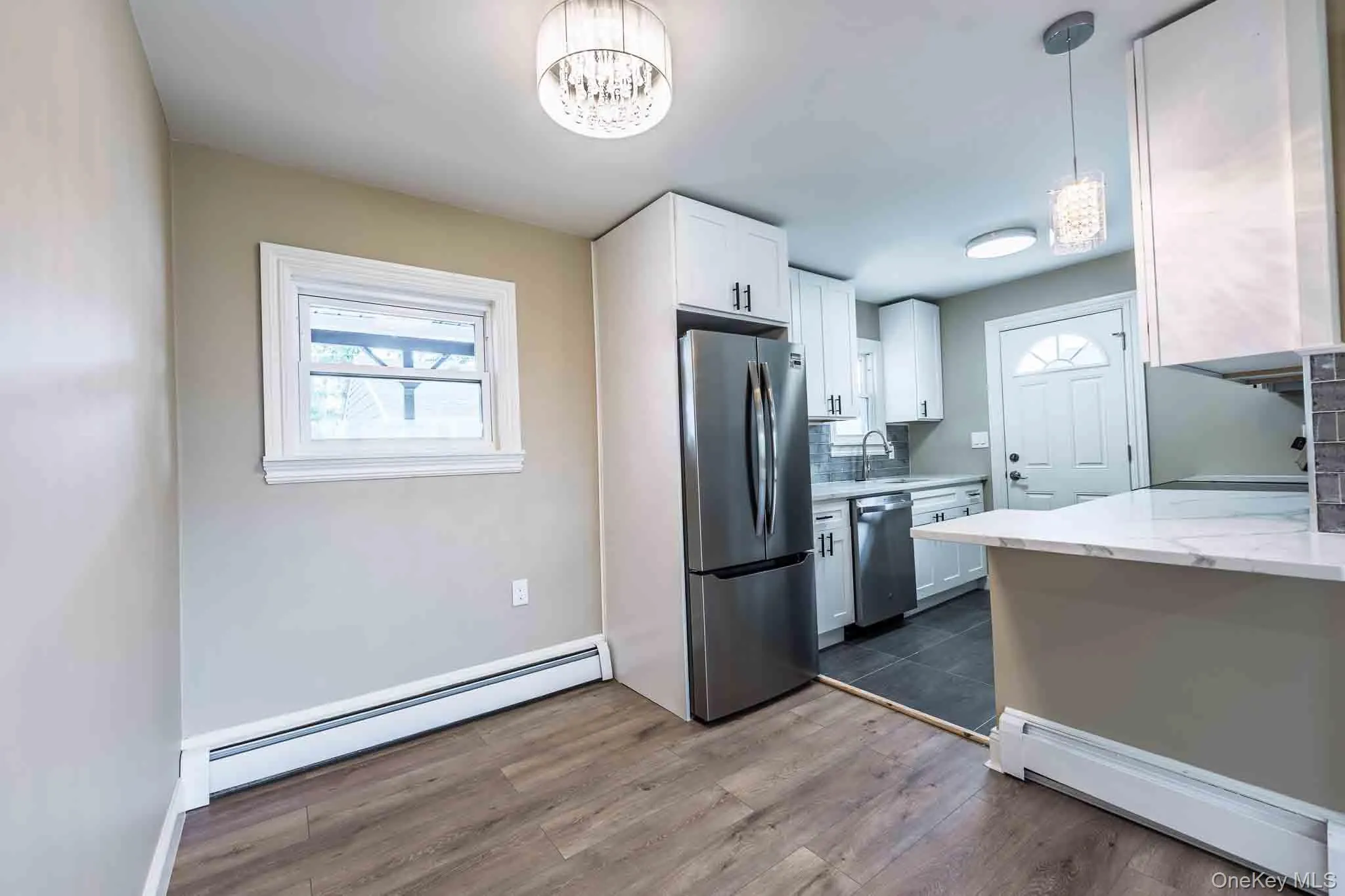 White shaker-style cabinetry with dark hardware White shaker-style cabinetry with dark hardware