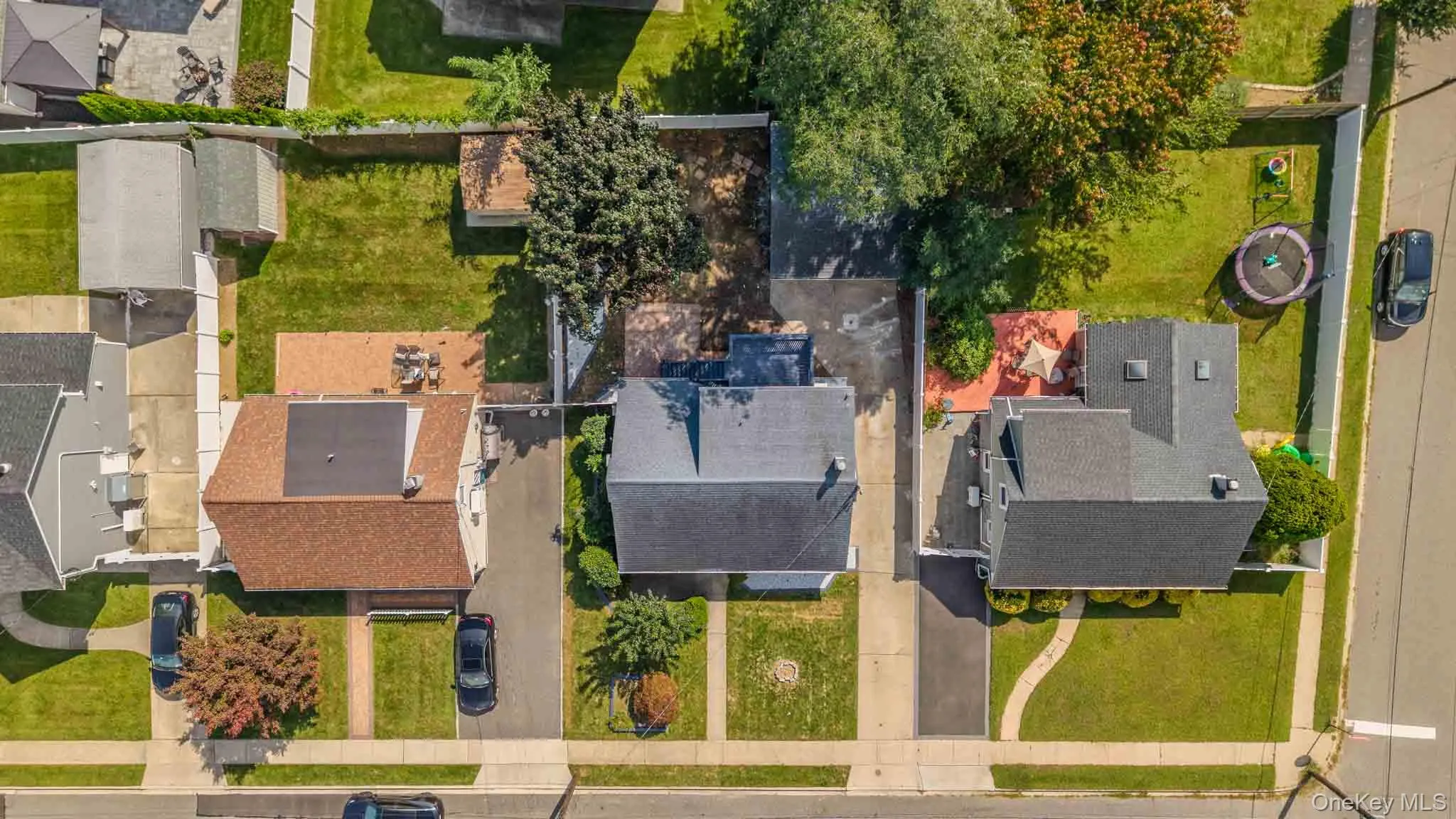 Expansive property featuring a large backyard, multiple detached structures, and paved driveways Expansive property featuring a large backyard, multiple detached structures, and paved driveways