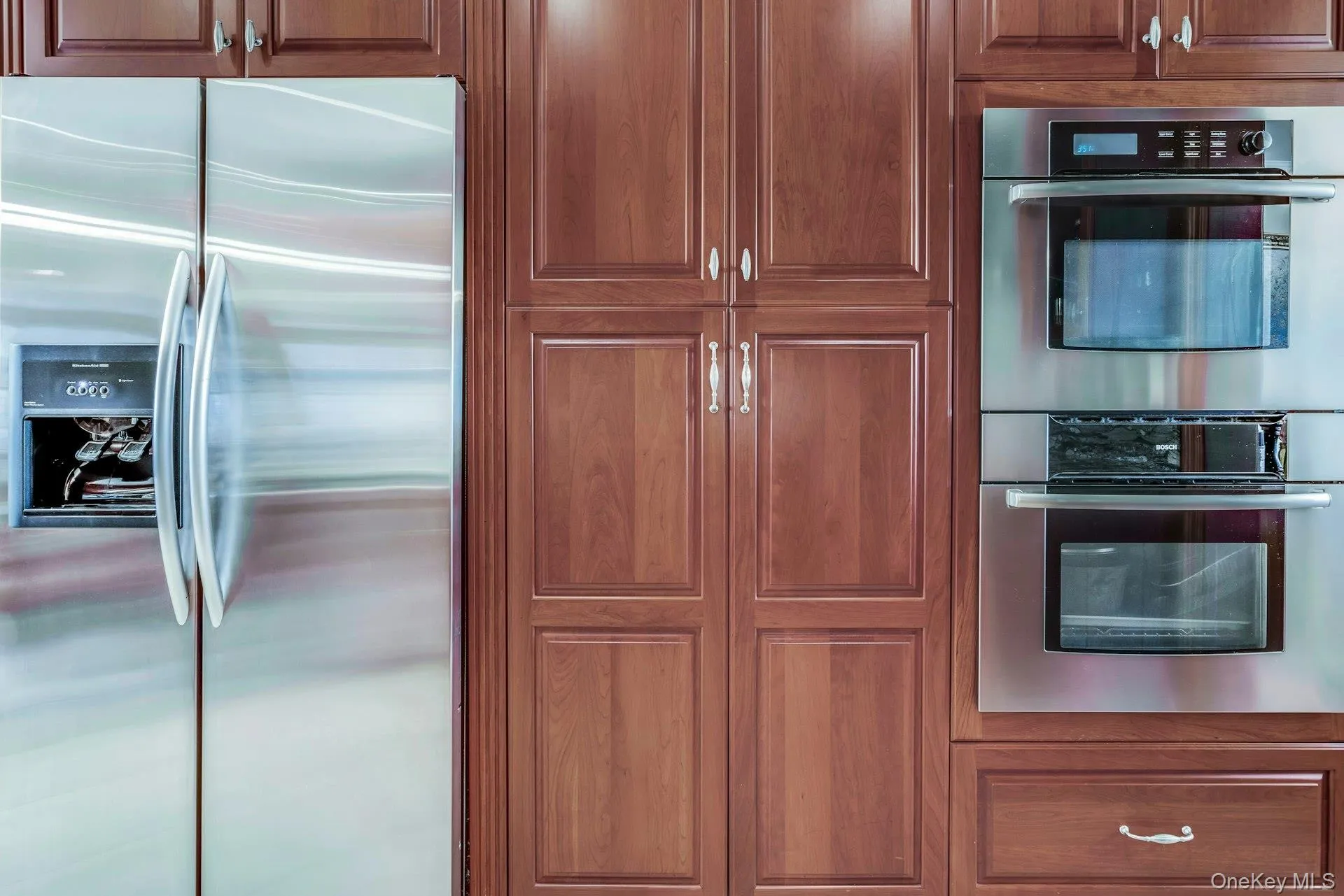 Stainless steel appliance including Bosch double oven and Kitchenaide French door refrigeraator with water and ice Stainless steel appliance including Bosch double oven and Kitchenaide French door refrigeraator with water and ice