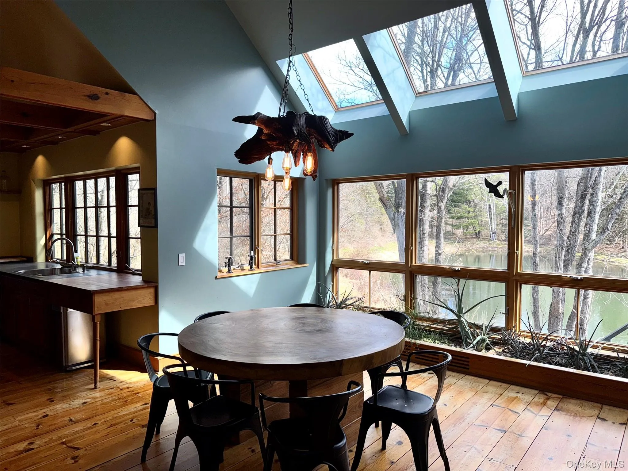 Dining room featuring Vaulted Ceiling and Wall of Winddows Dining room featuring Vaulted Ceiling and Wall of Winddows
