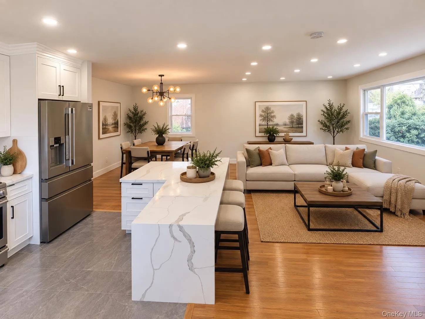 VIRTUALLY STAGED Gourmet kitchen with an expansive island, white cabinetry, and stainless steel refrigerator VIRTUALLY STAGED Gourmet kitchen with an expansive island, white cabinetry, and stainless steel refrigerator