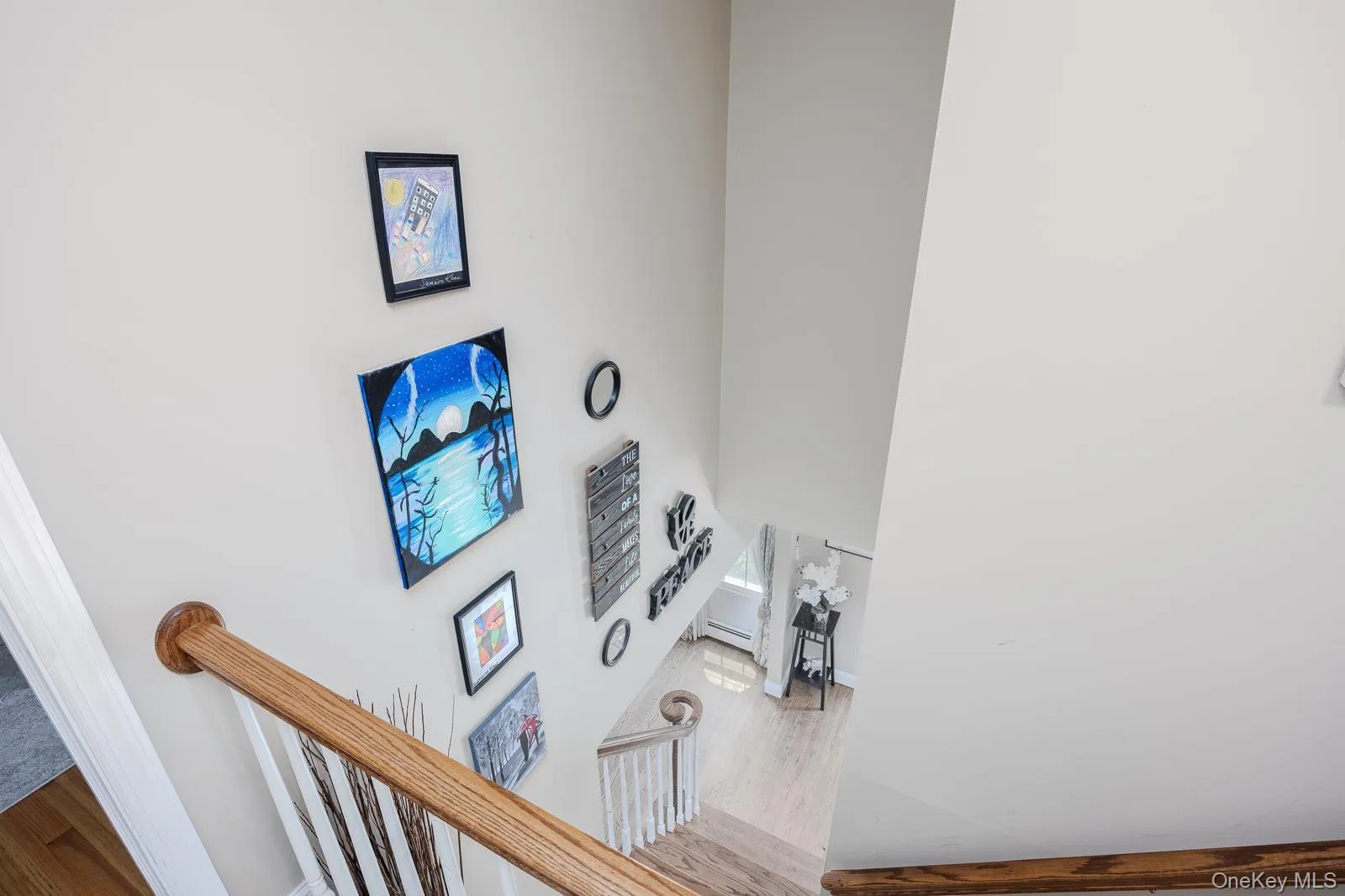 Two-story wall, wood-finish handrail, white painted risers, and wood-finish flooring Two-story wall, wood-finish handrail, white painted risers, and wood-finish flooring