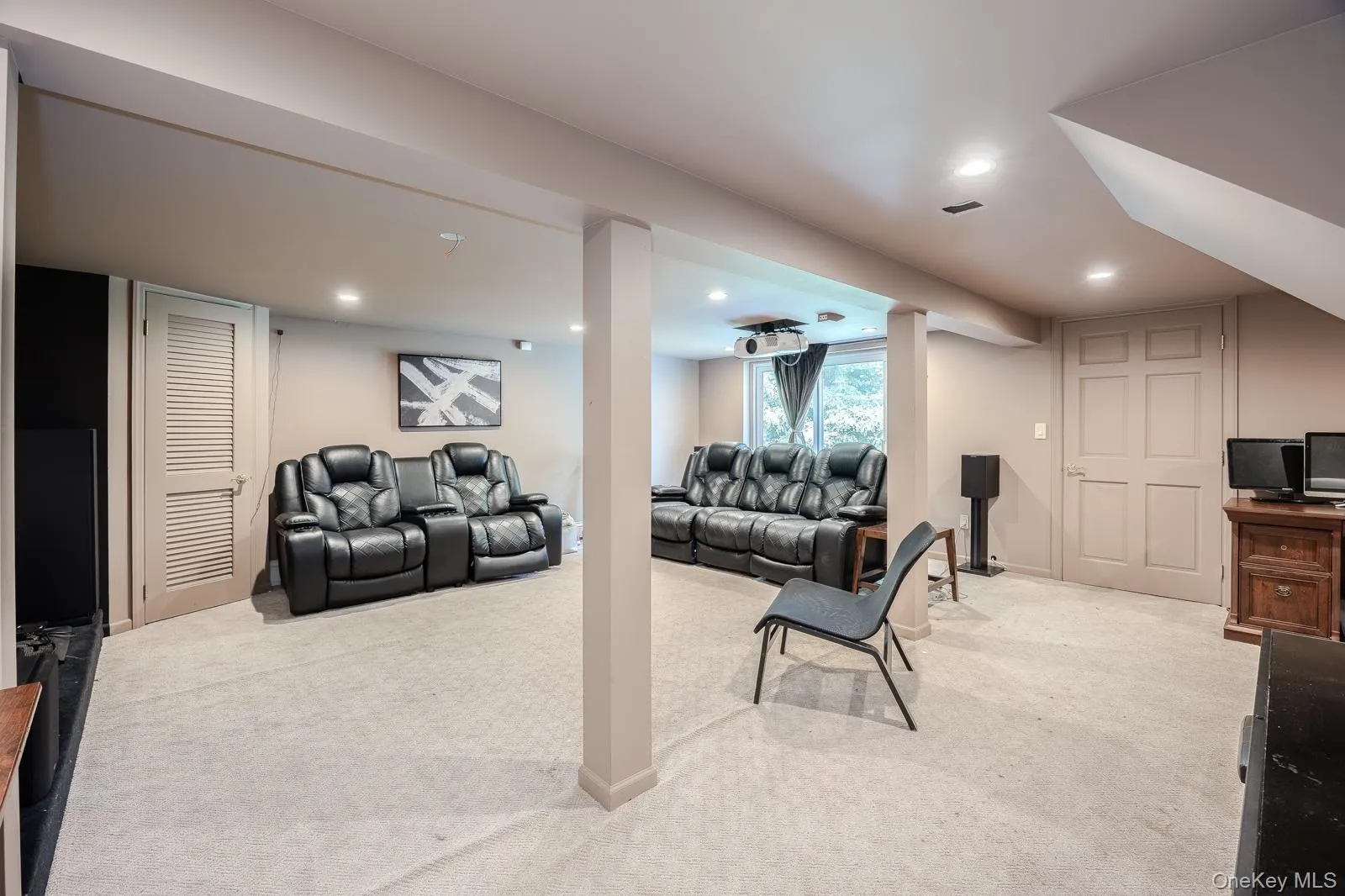 Recessed lighting, light-toned carpeting, and a built-in projector Recessed lighting, light-toned carpeting, and a built-in projector