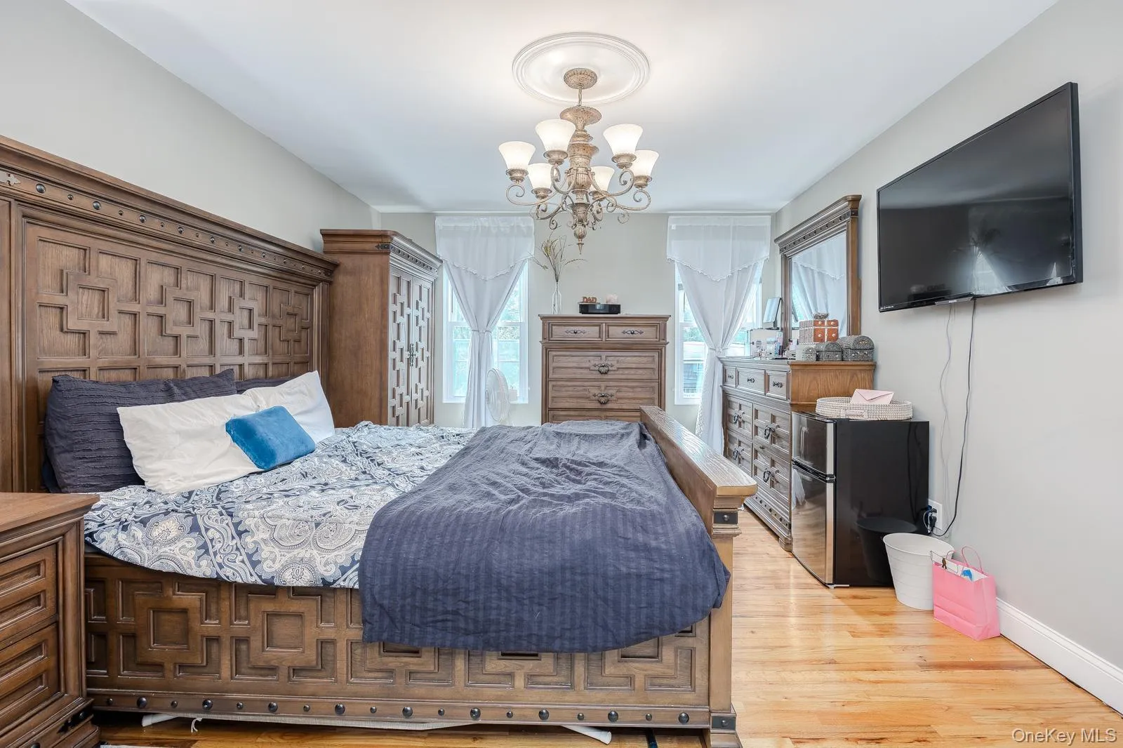 Master bedroom hardwood flooring, recessed lighting, ceiling medallion, and a multi-arm chandelier Master bedroom hardwood flooring, recessed lighting, ceiling medallion, and a multi-arm chandelier