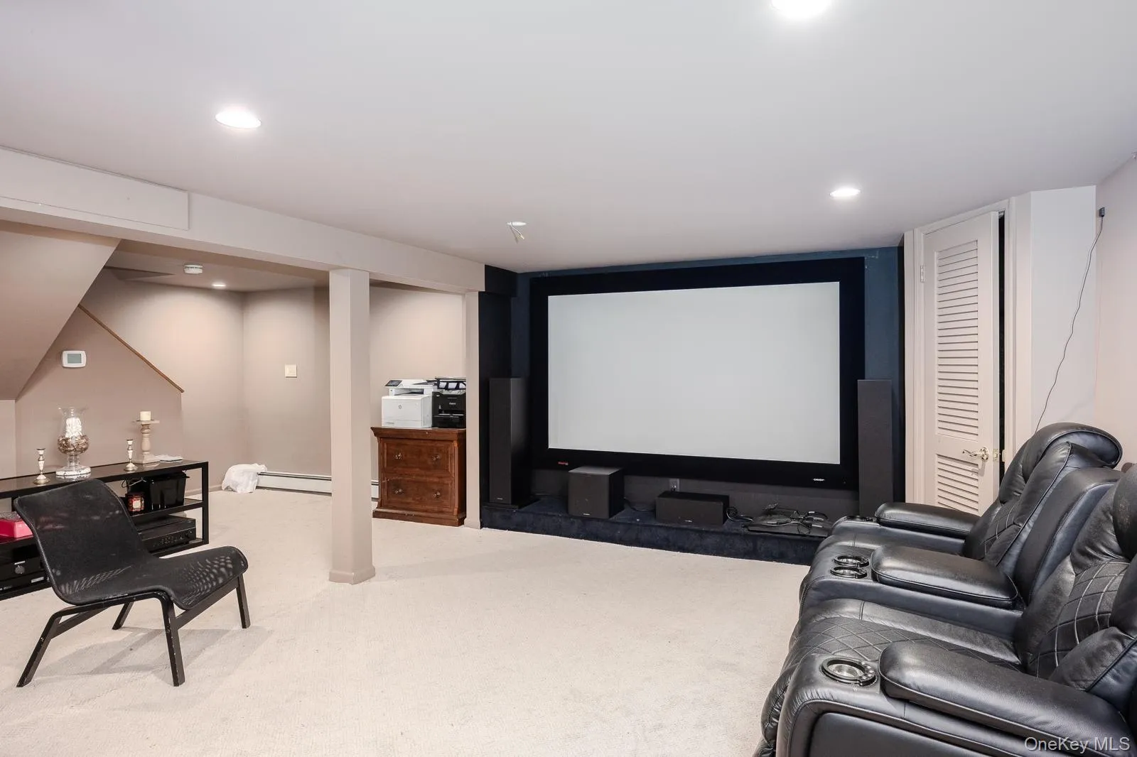 Entertainment area featuring a large projection screen, recessed lighting, and carpet flooring Entertainment area featuring a large projection screen, recessed lighting, and carpet flooring