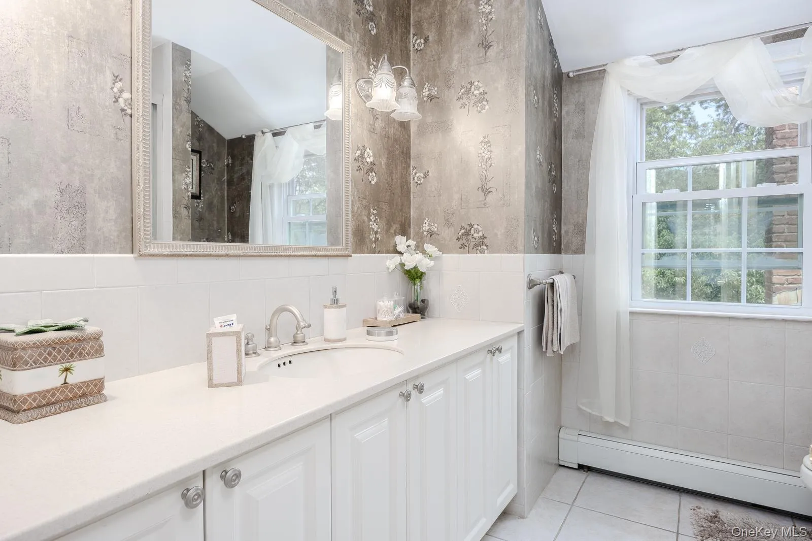 Dual-basin vanity with ample counter space, integrated sink, and white cabinetry Dual-basin vanity with ample counter space, integrated sink, and white cabinetry