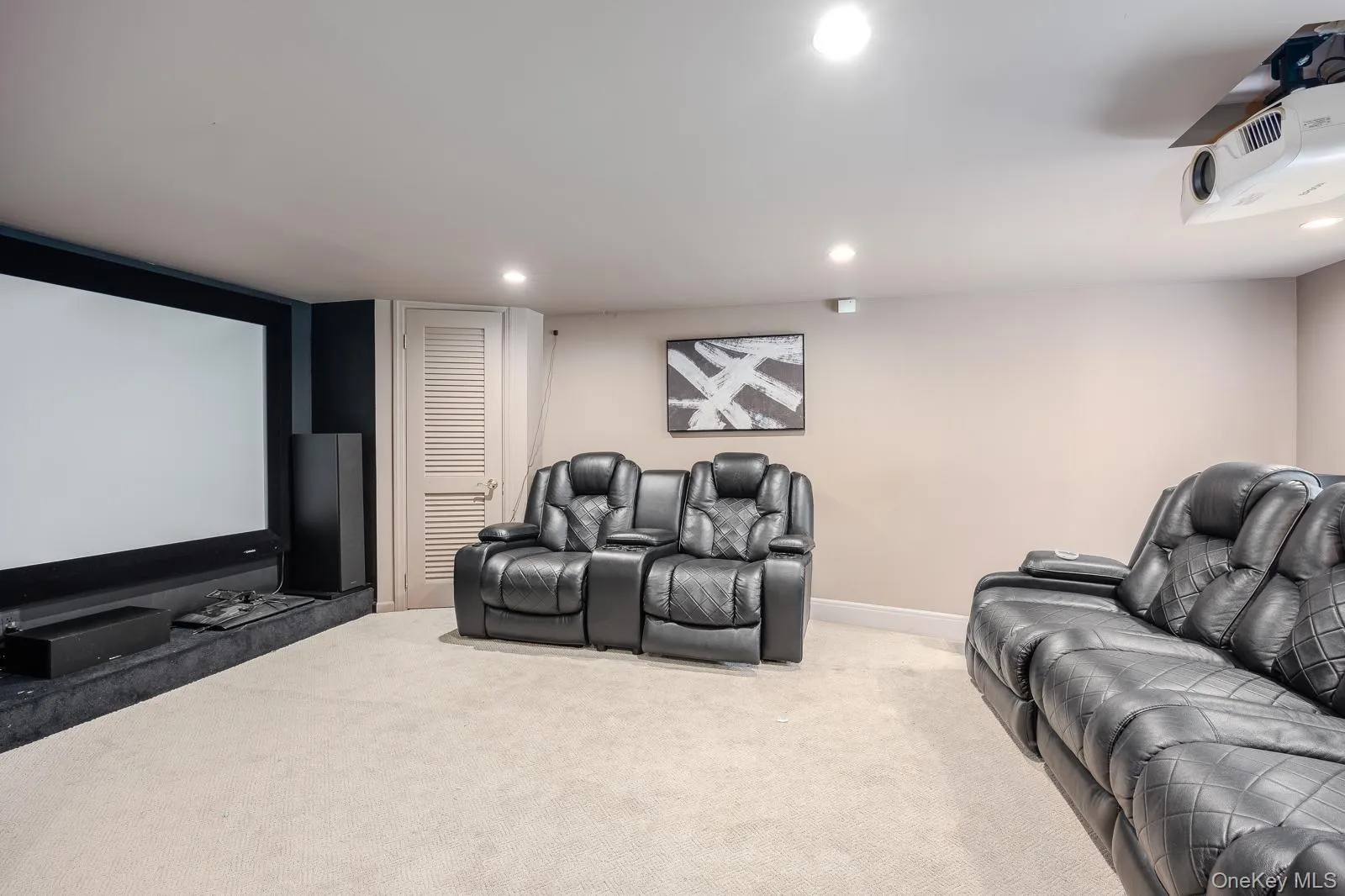 Media room featuring a large projection screen, projector, and recessed ceiling lighting Media room featuring a large projection screen, projector, and recessed ceiling lighting
