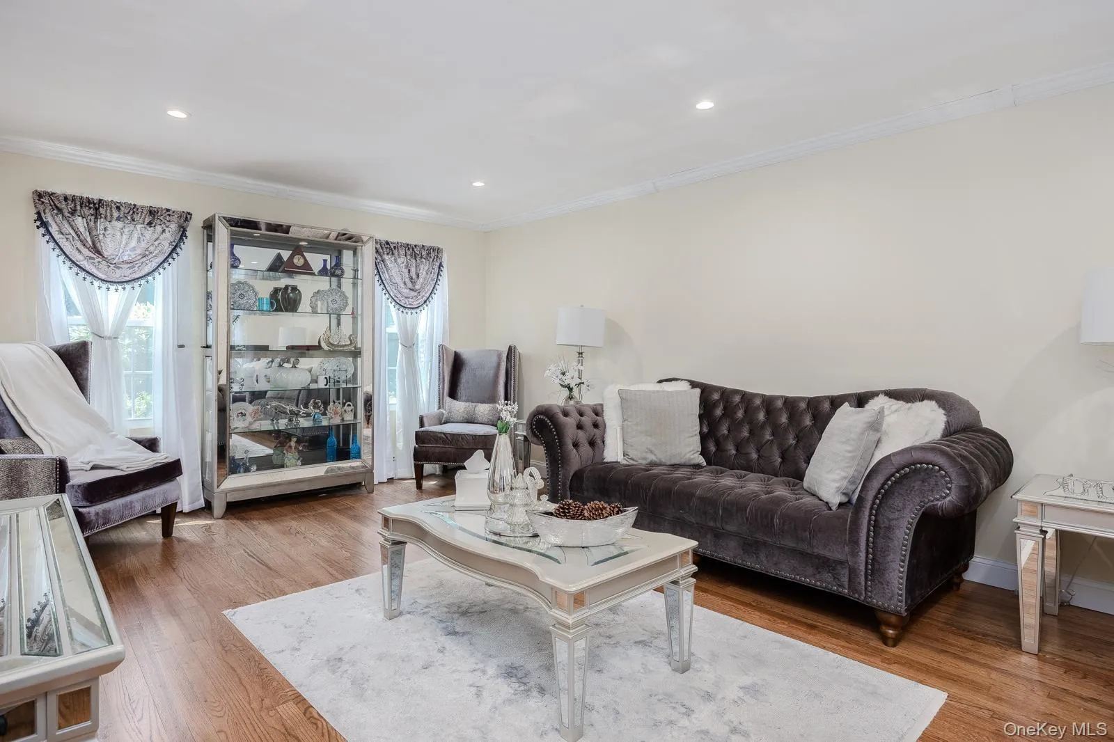 Recessed lighting, crown molding, wood-finish flooring, and white wall finishes Recessed lighting, crown molding, wood-finish flooring, and white wall finishes