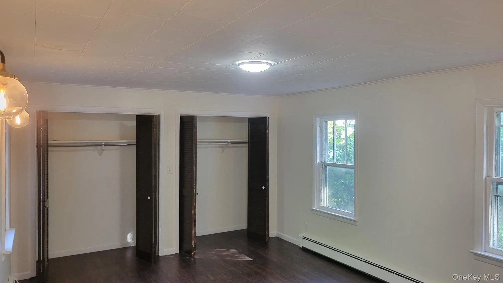Wood-finish flooring with white walls and trim Wood-finish flooring with white walls and trim
