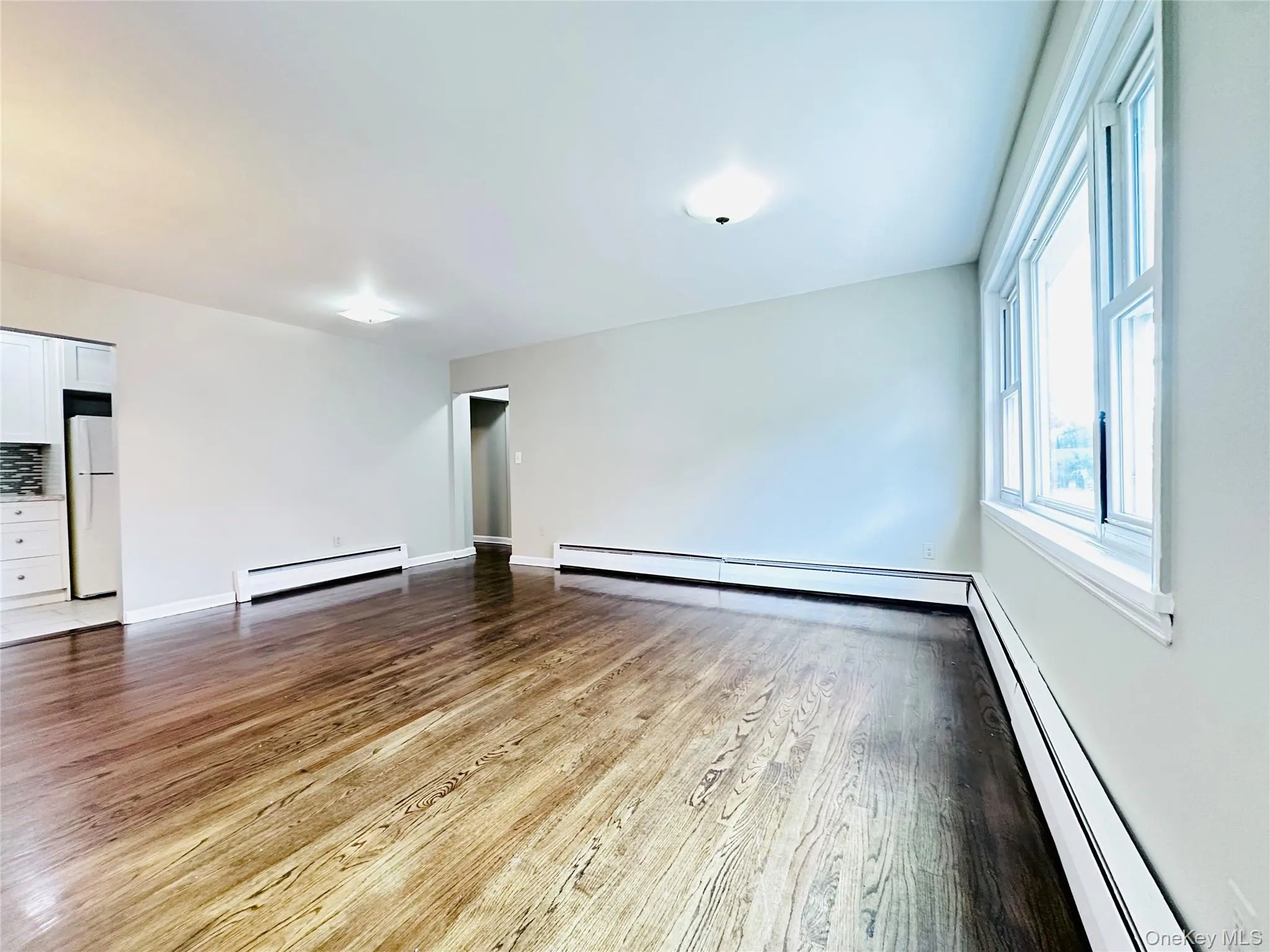 With Wood-finish flooring, fresh painted walls, multiple windows, and ceiling-mounted lighting fixtures With Wood-finish flooring, fresh painted walls, multiple windows, and ceiling-mounted lighting fixtures