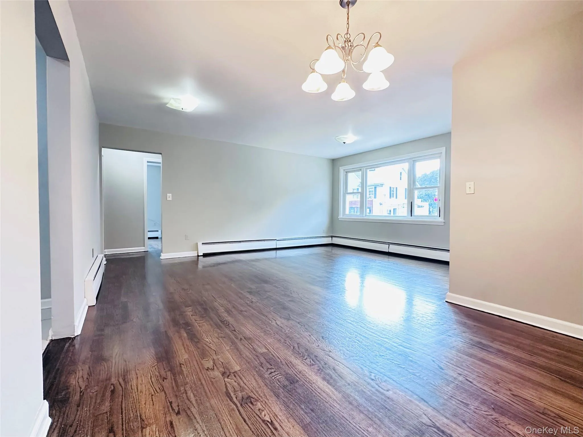 And dining area in a Spacious room featuring wood-finish flooring, multiple windows, ceiling light fixtures, and light-toned walls And dining area in a Spacious room featuring wood-finish flooring, multiple windows, ceiling light fixtures, and light-toned walls