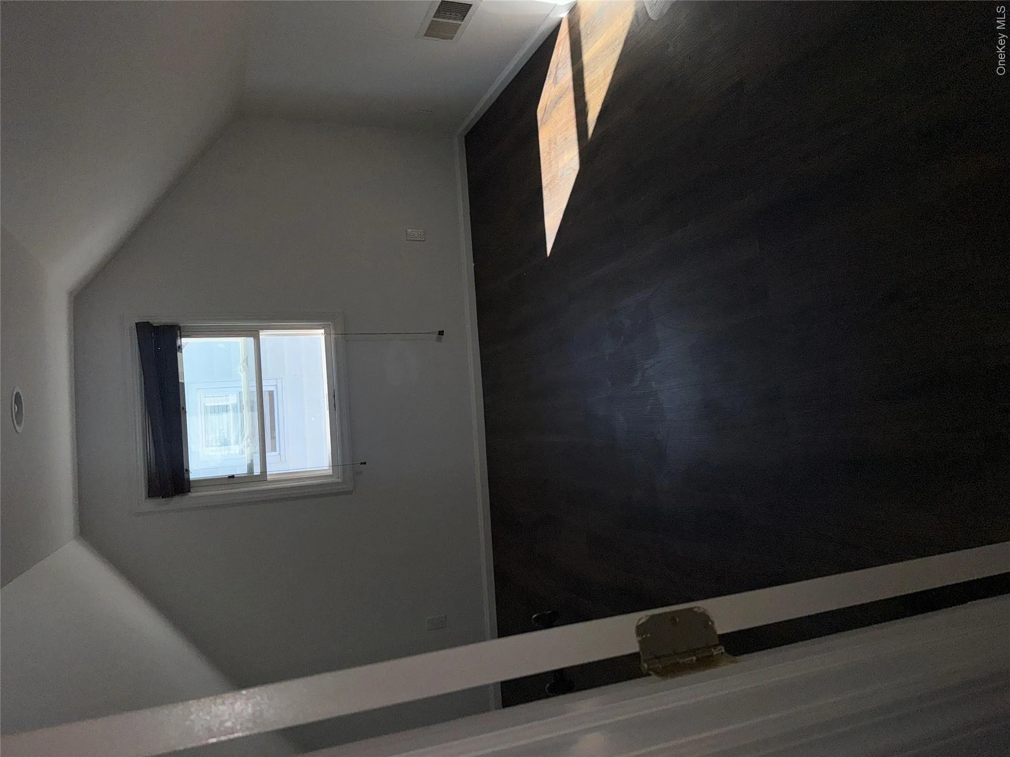 Wood-finish flooring with a window, recessed lighting, and sloped ceilings Wood-finish flooring with a window, recessed lighting, and sloped ceilings
